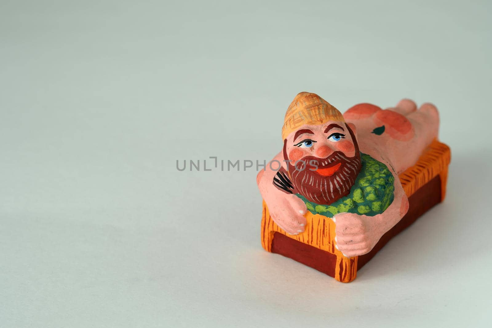 Funny handmade ceramic figurines.The man in the bath.Souvenir and clay.