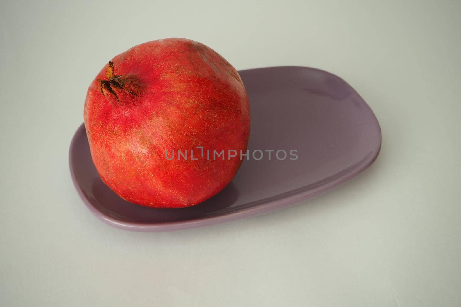 Pomegranate ripe, red round fruit. On a white background