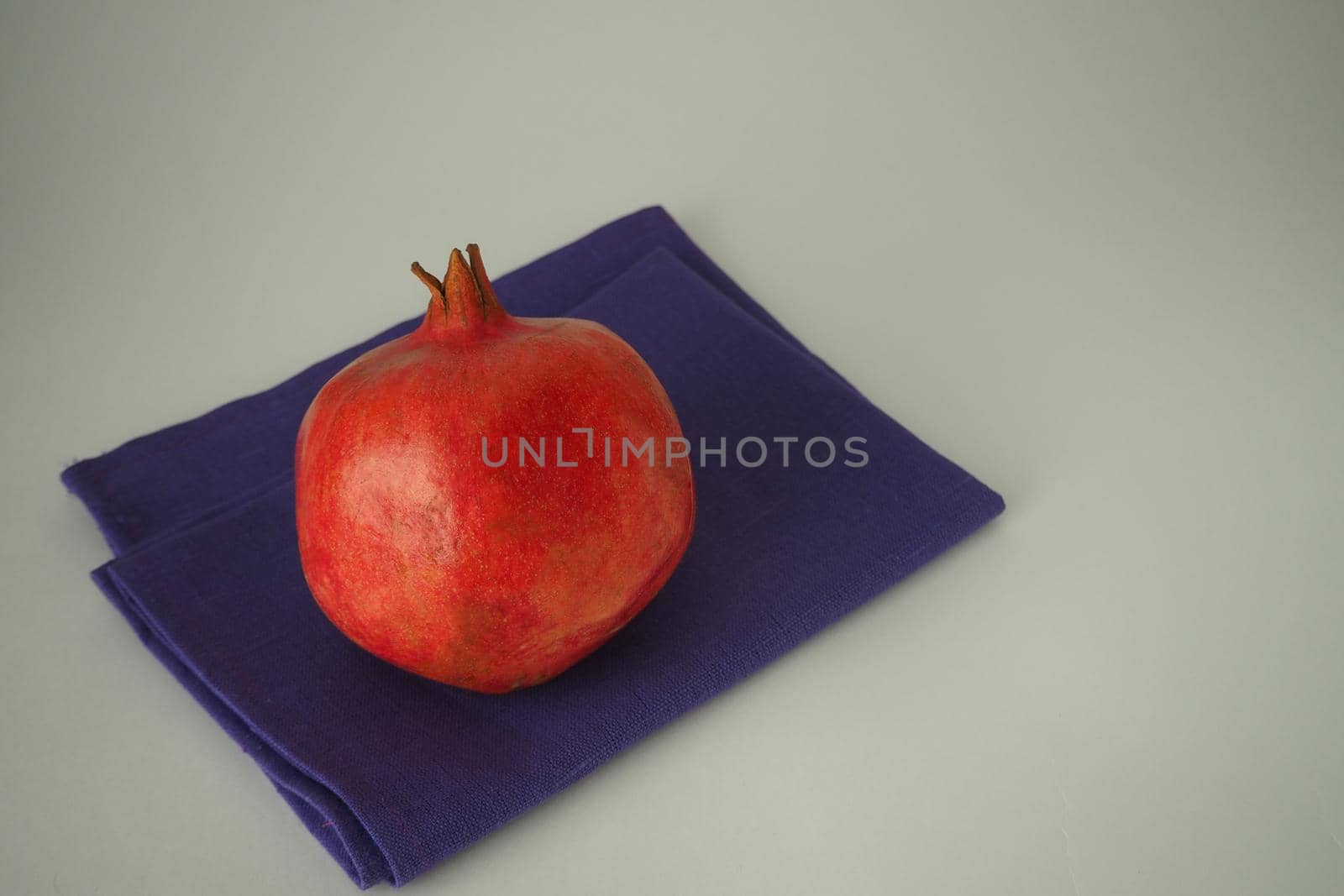 Grenades. Ripe fruit on a white background. Red grenade. by Olga26