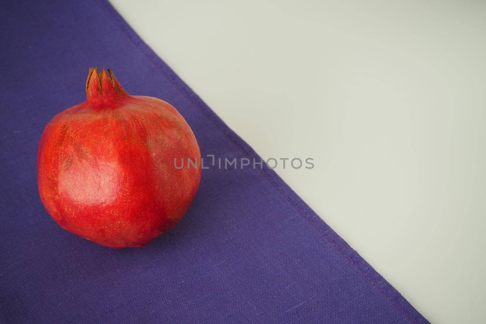 Ripe pomegranate. The red fruit of the fruit. Close-up.