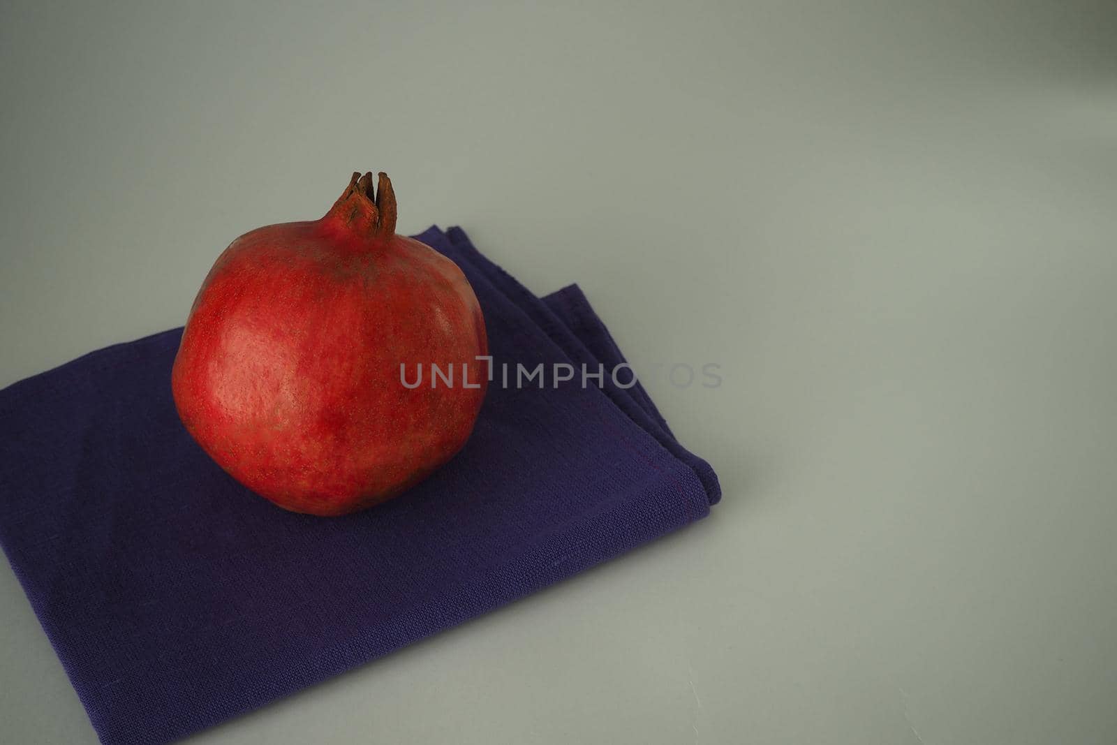 Ripe pomegranate. The red fruit of the fruit. Close-up.