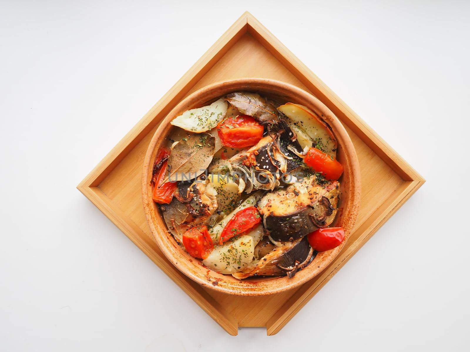 A dish of fish with vegetables baked in the oven. Close-up.