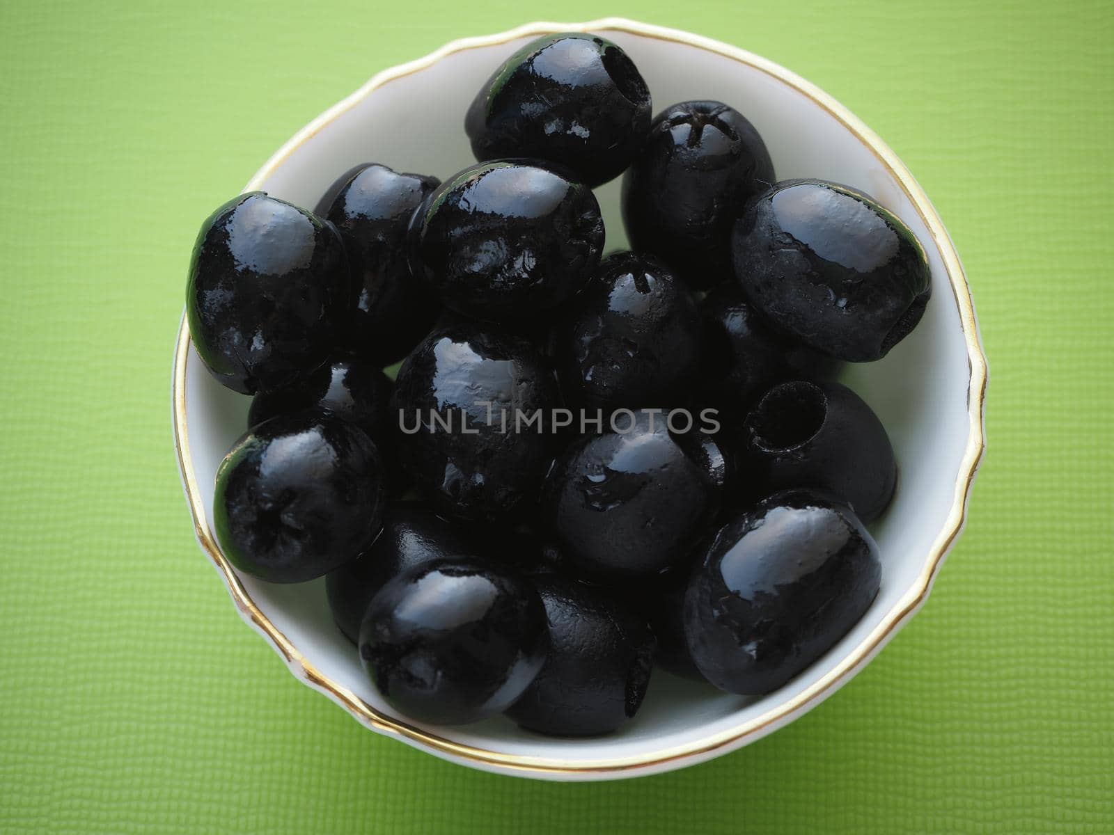 Black olives in a salad bowl, close-up. by Olga26