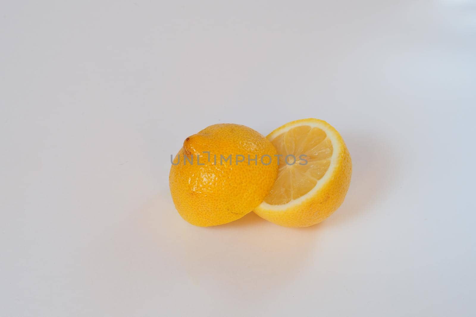 Lemon. Cut in half. Close-up, white background. High quality photo. High quality photo