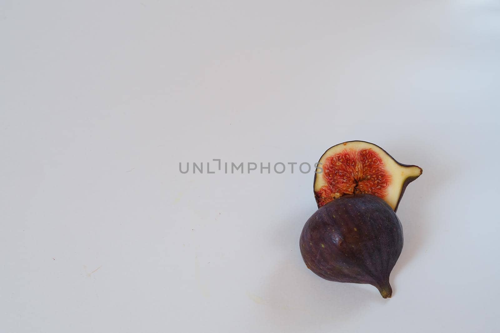 Food. Exotic fruit. Purple figs close up on a white background. by Olga26