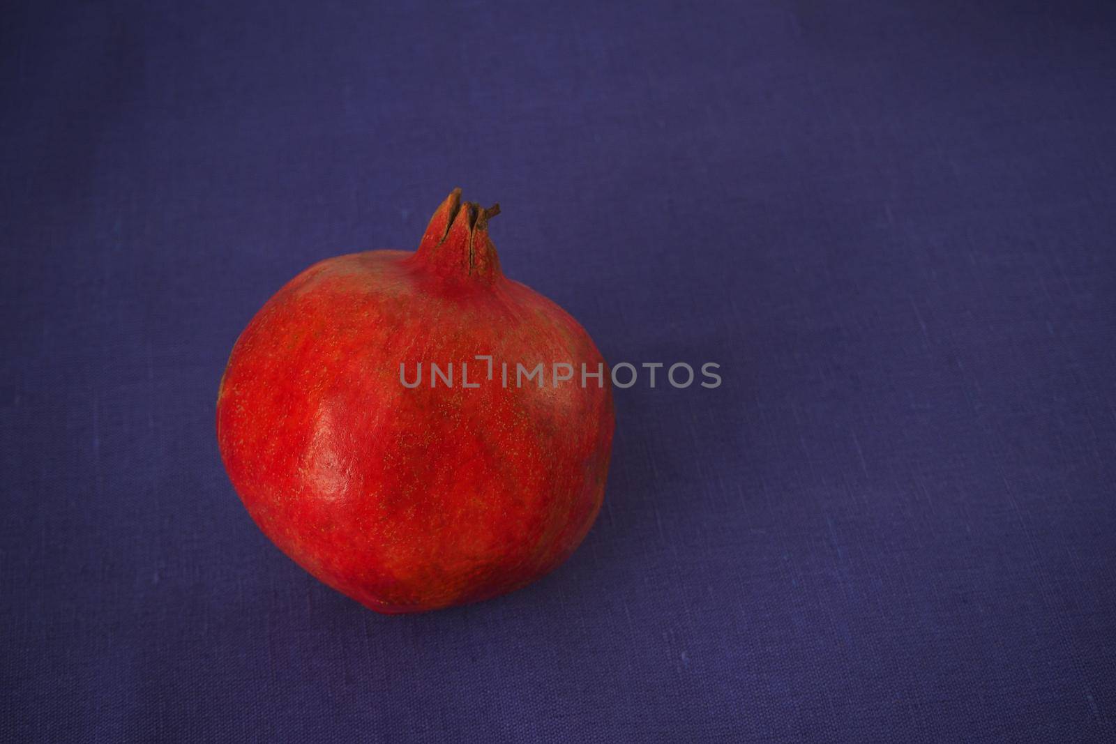 Ripe pomegranate. The red fruit of the fruit. Close-up.