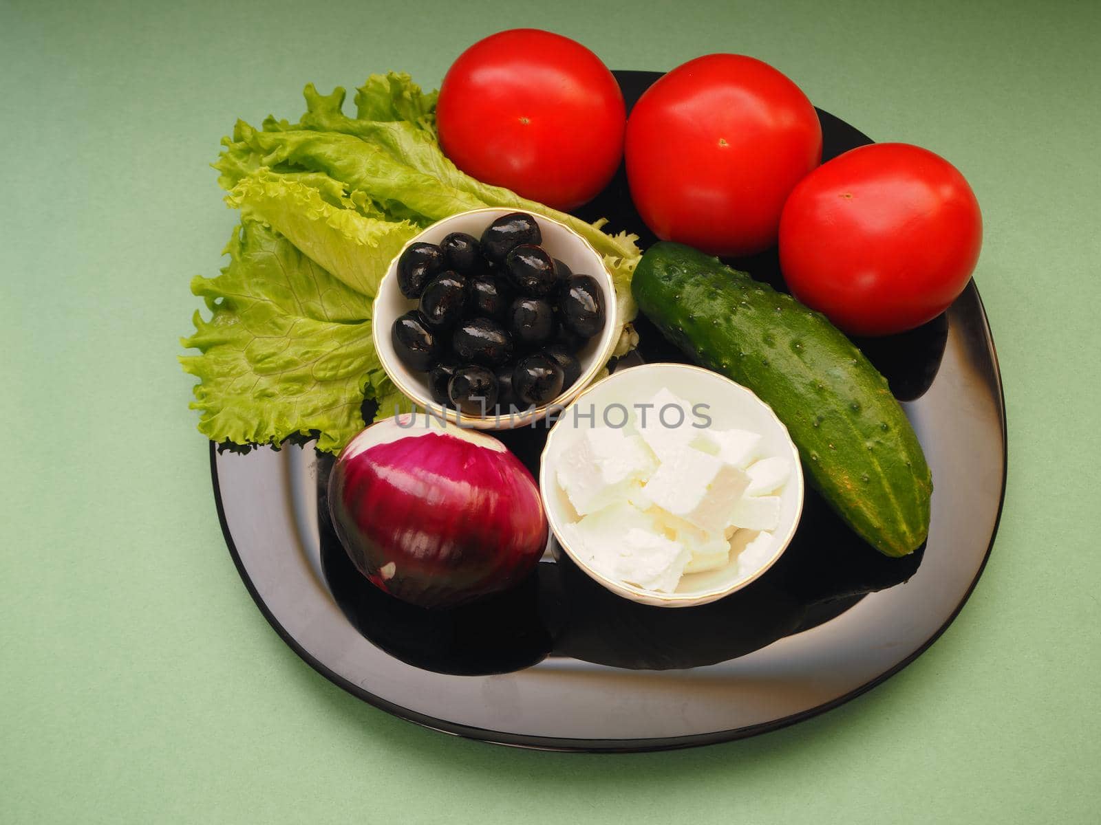 Greek fresh vegetable salad, feta cheese, olives and red onions.