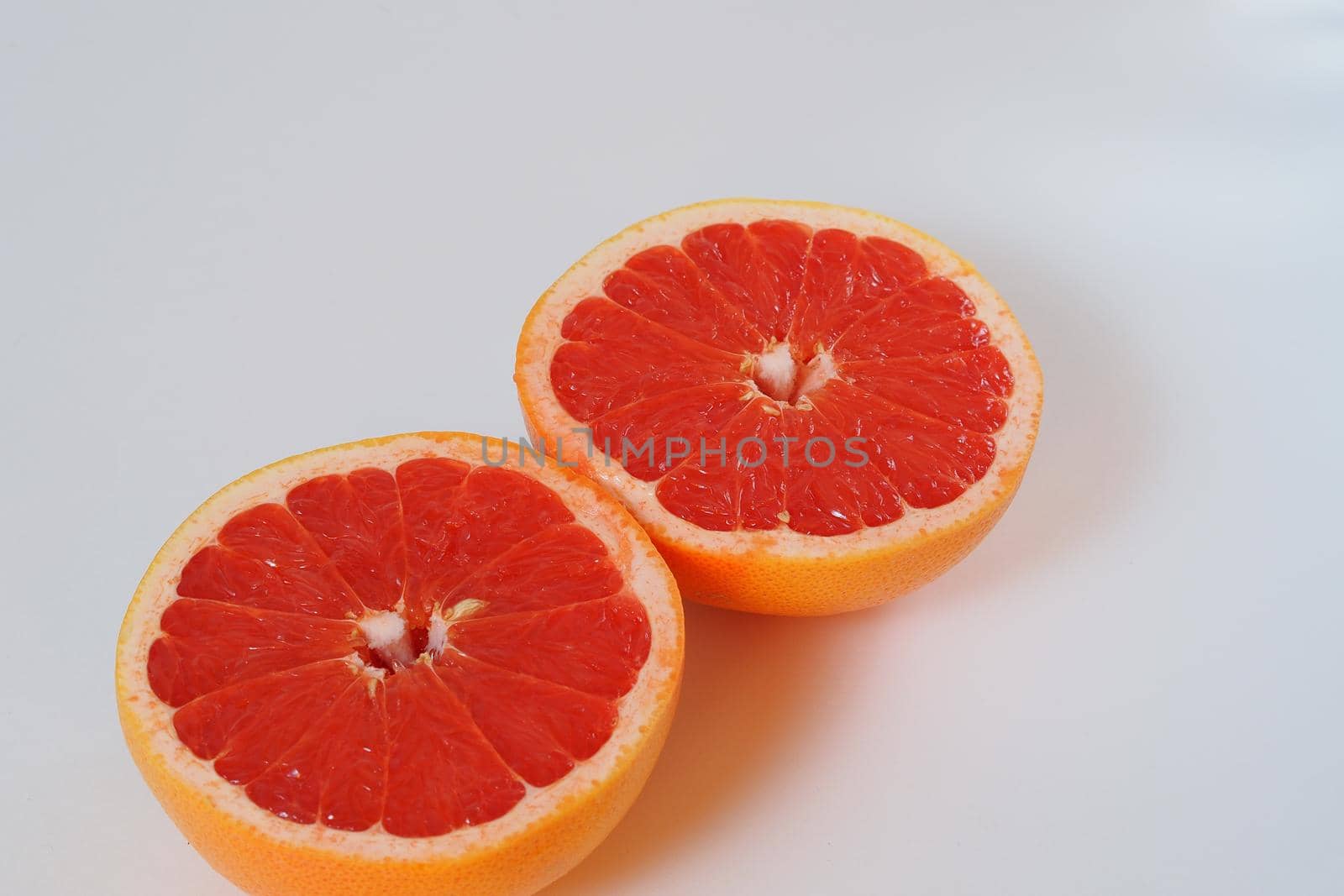 Fruits are citrus fruits. Red grapefruit cut in half. High quality photo