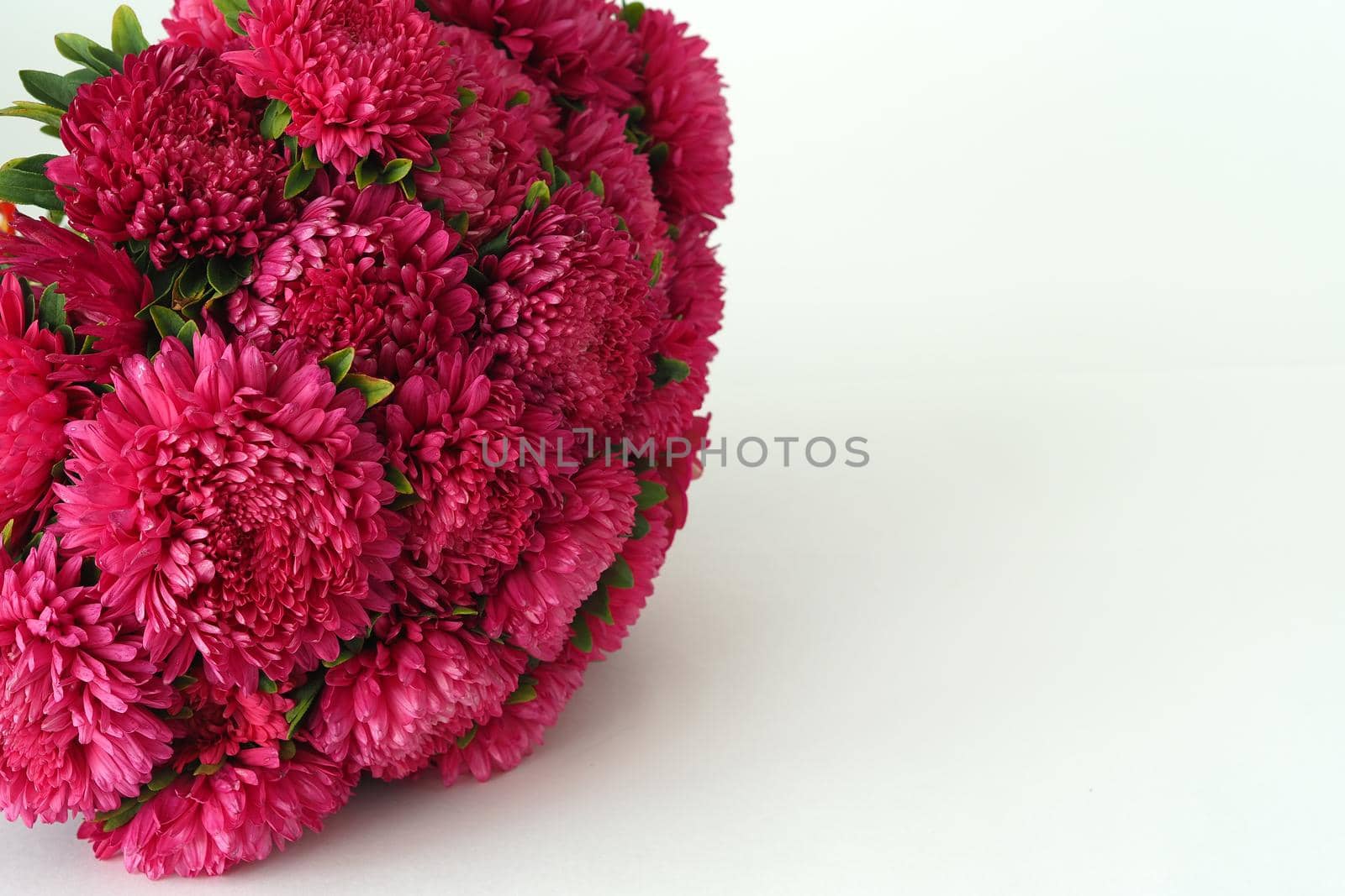 Bouquet of flowers. Asters are pink. Close-up, on a white background.