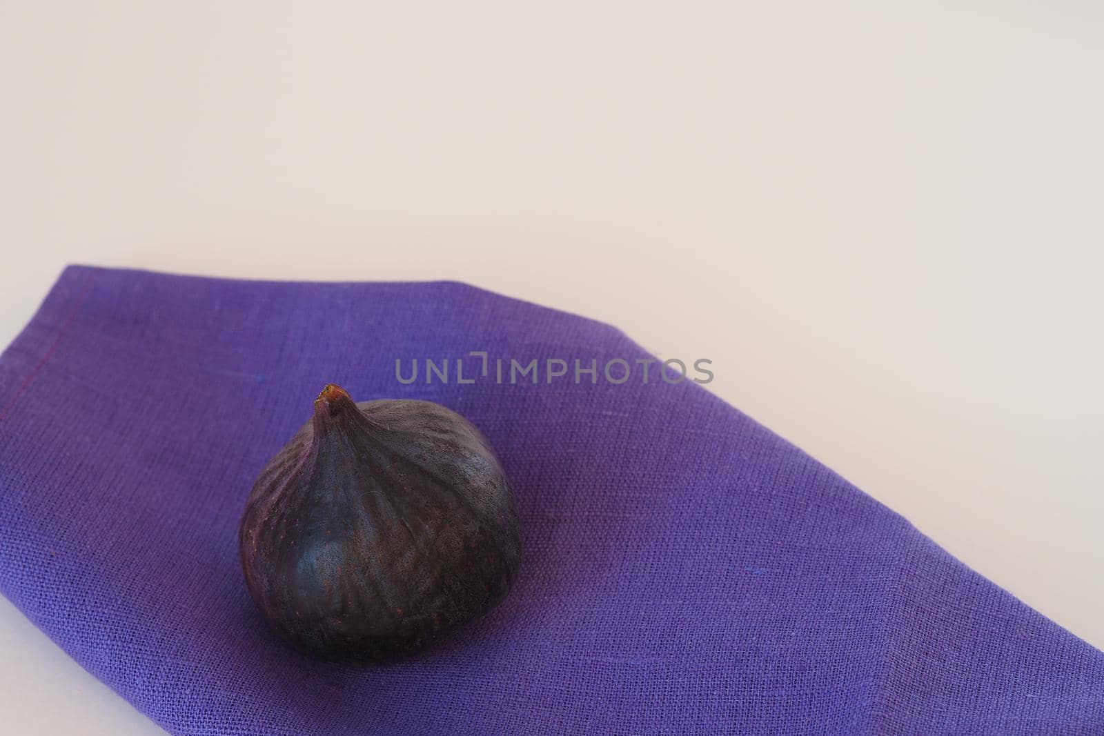 Purple figs n blue napkin. A whole fruit, not cut. by Olga26