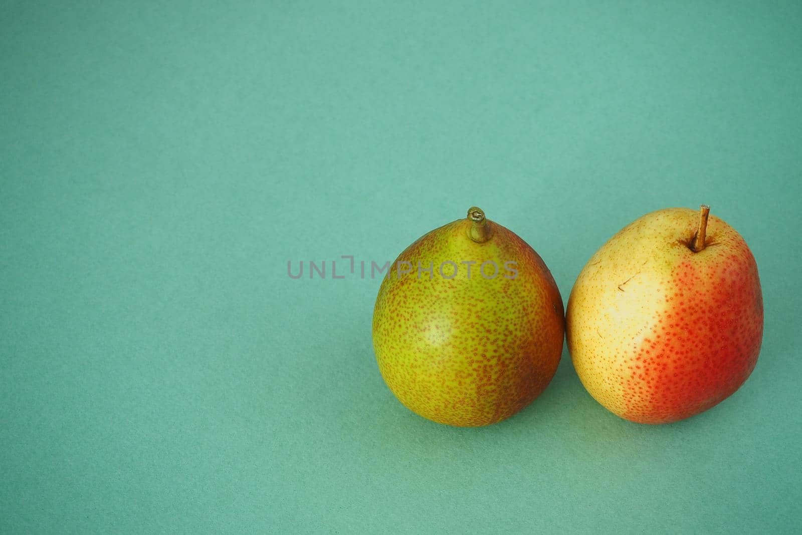 Ripe pears close up on a green background. by Olga26