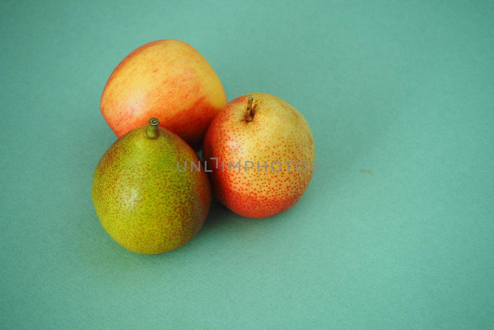 Ripe pears and apples on a ripe background. Close-up.