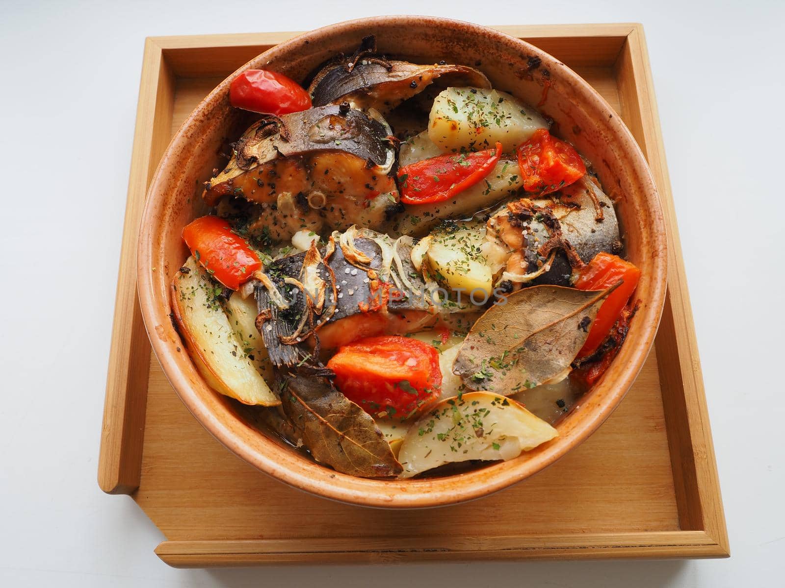 A dish of fish with vegetables baked in the oven. Close-up.