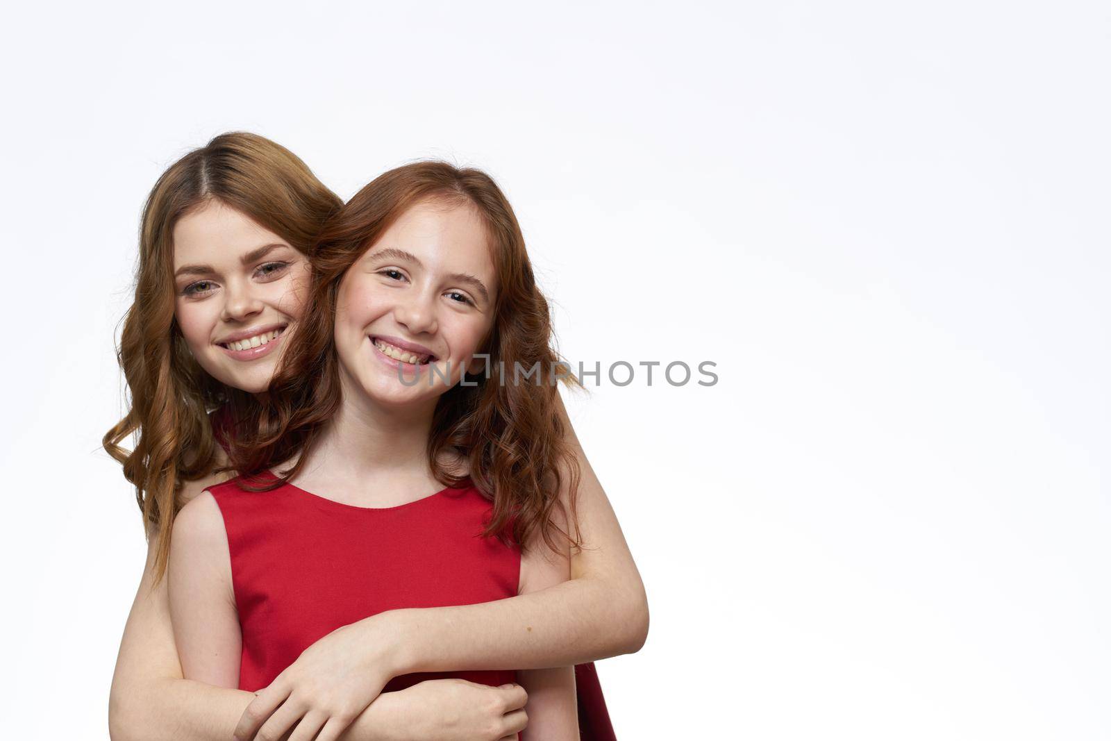 Mom and daughter stand side by side and fun family joy light background by SHOTPRIME