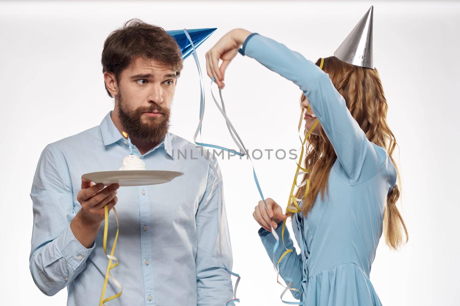 Joyful man and cheerful Woman holiday cake Birthday cap party corporate party young people. High quality photo
