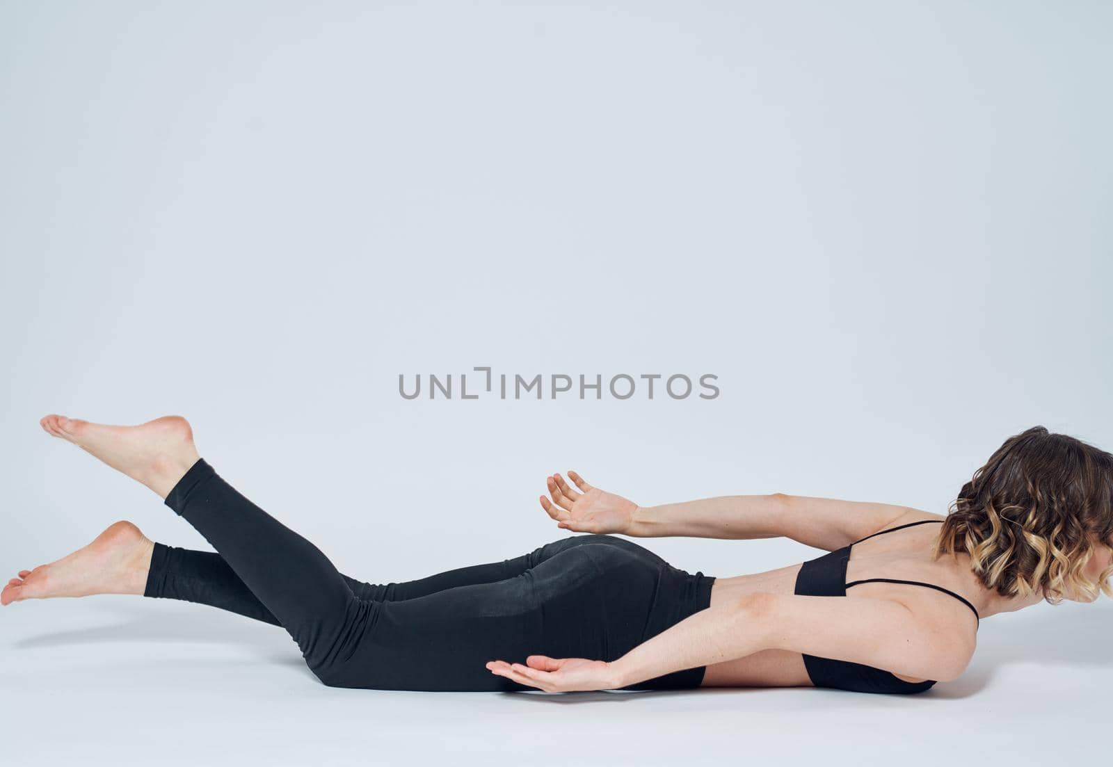 Women lies on the floor In a light room, sport yoga asanas. High quality photo