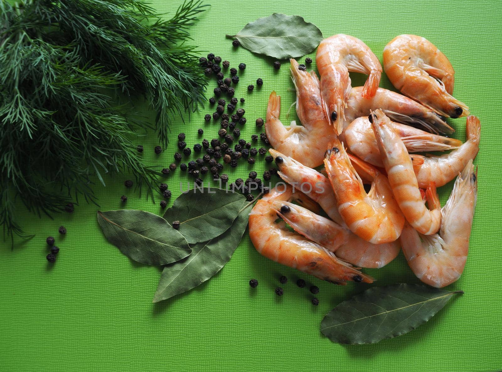 Large prawns with spices and spaghetti. Prawns with dill and pepper close-up. Bright background.