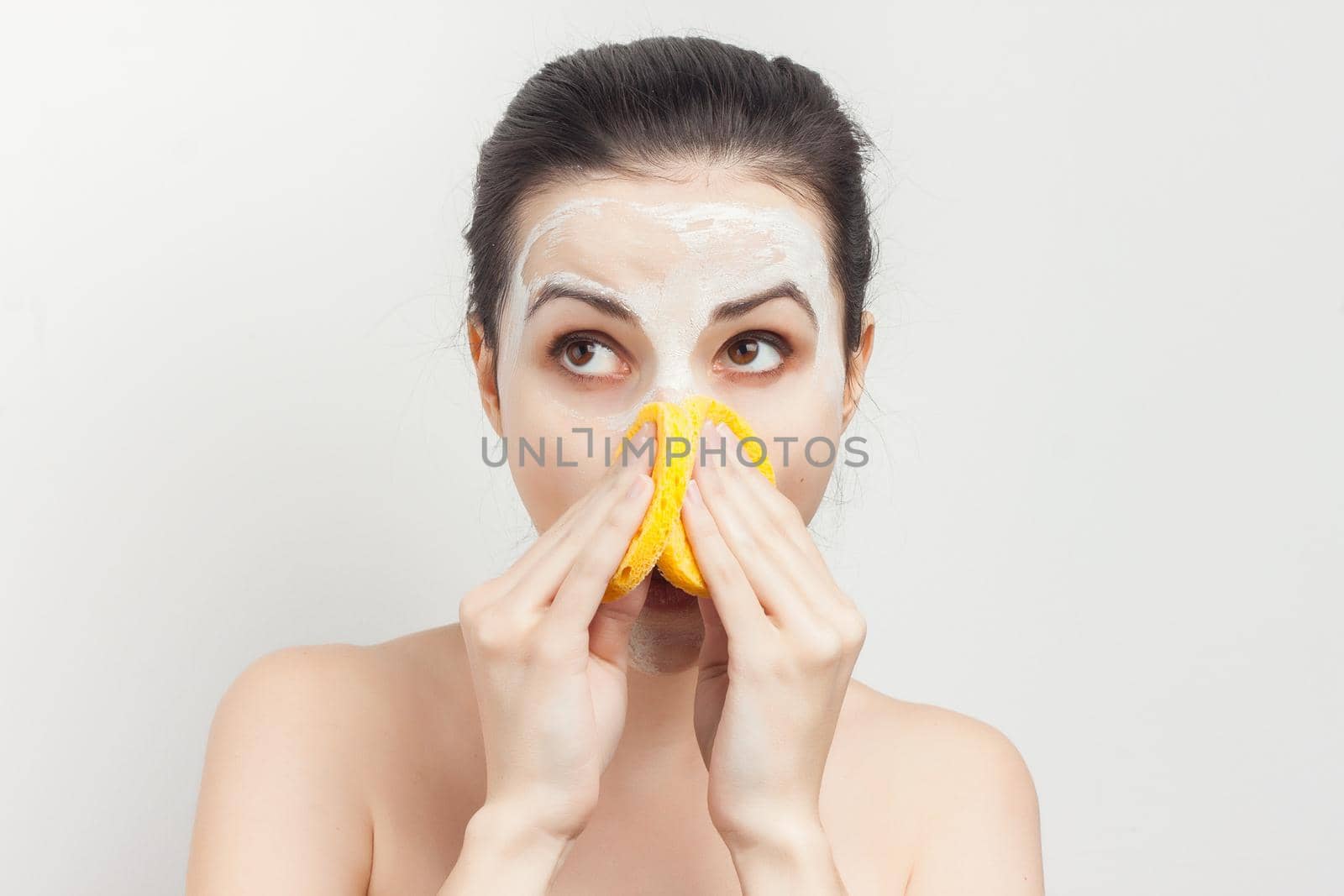 brunette with bare shoulders skin care cream cosmetics hygiene. High quality photo