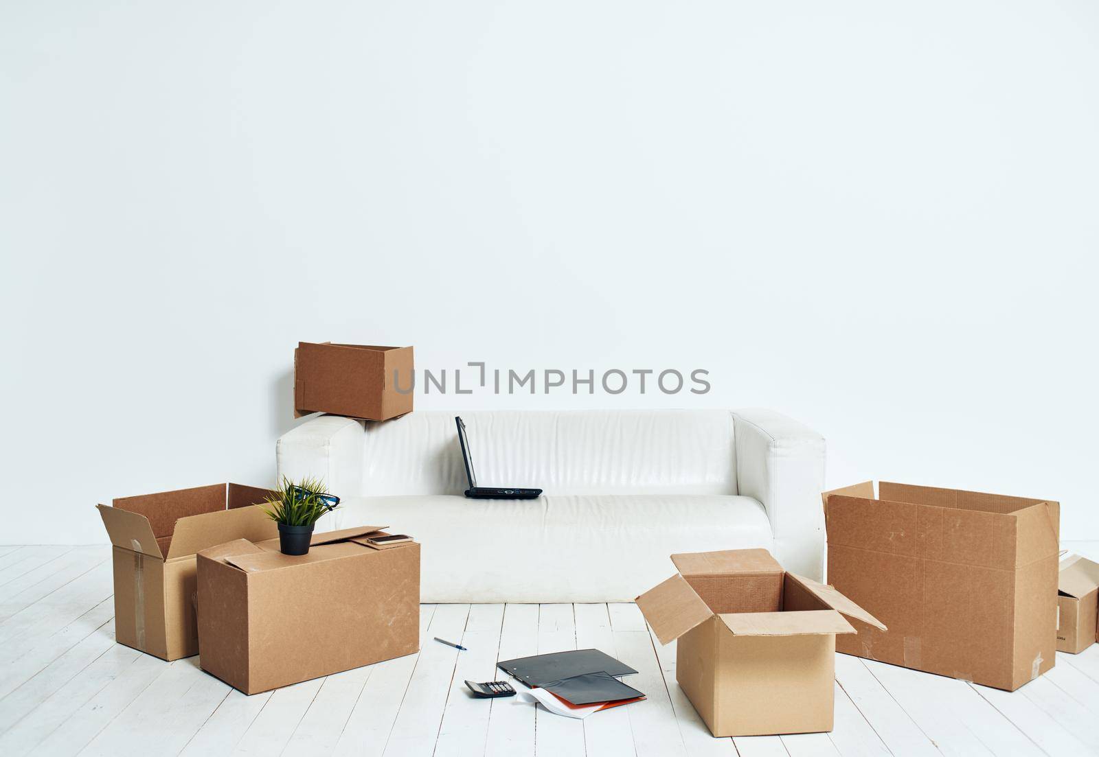 Boxes with things white sofa unpacking office moving. High quality photo