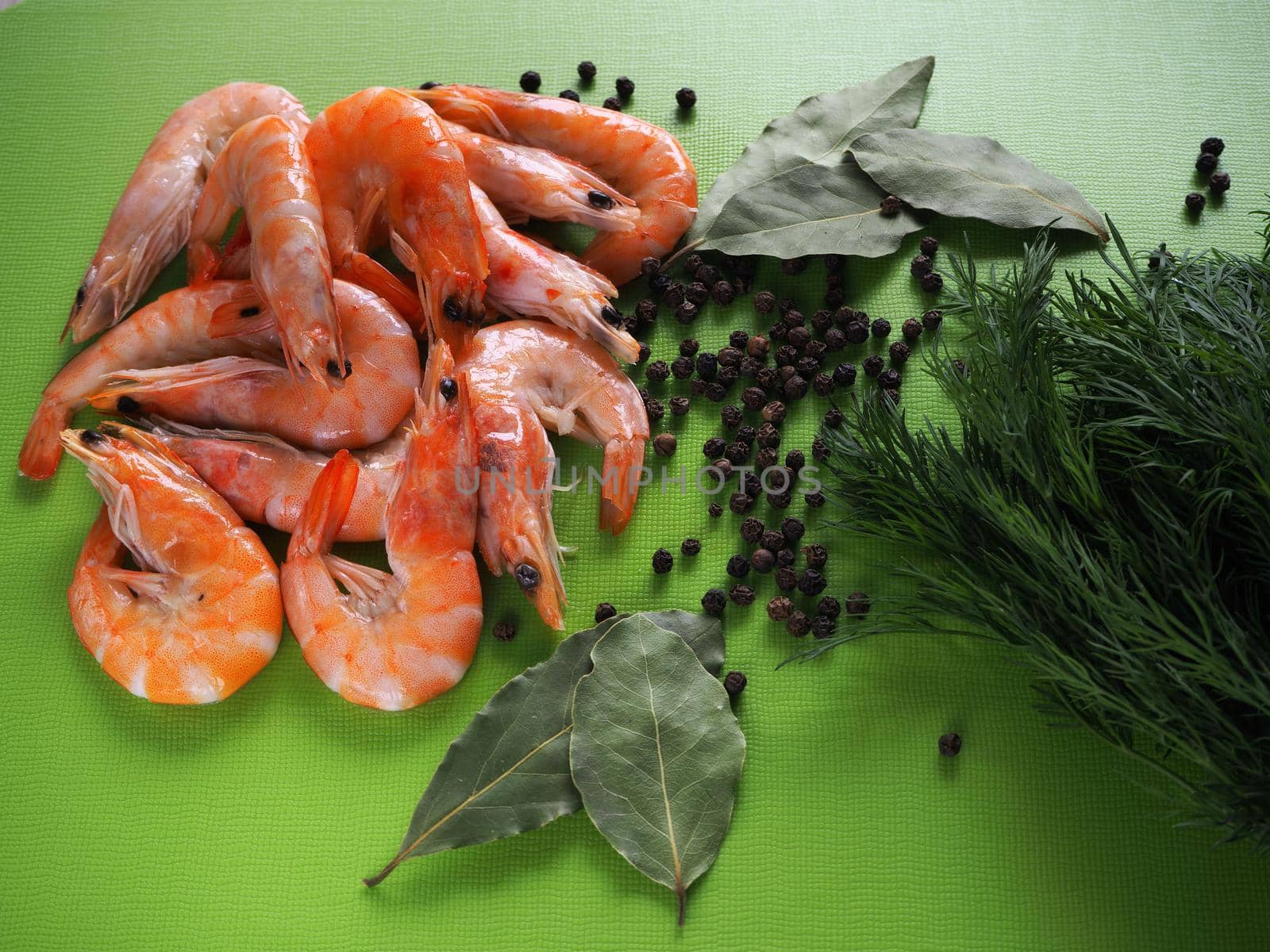 Large prawns with spices and spaghetti. Prawns with dill and pepper close-up. Bright background.