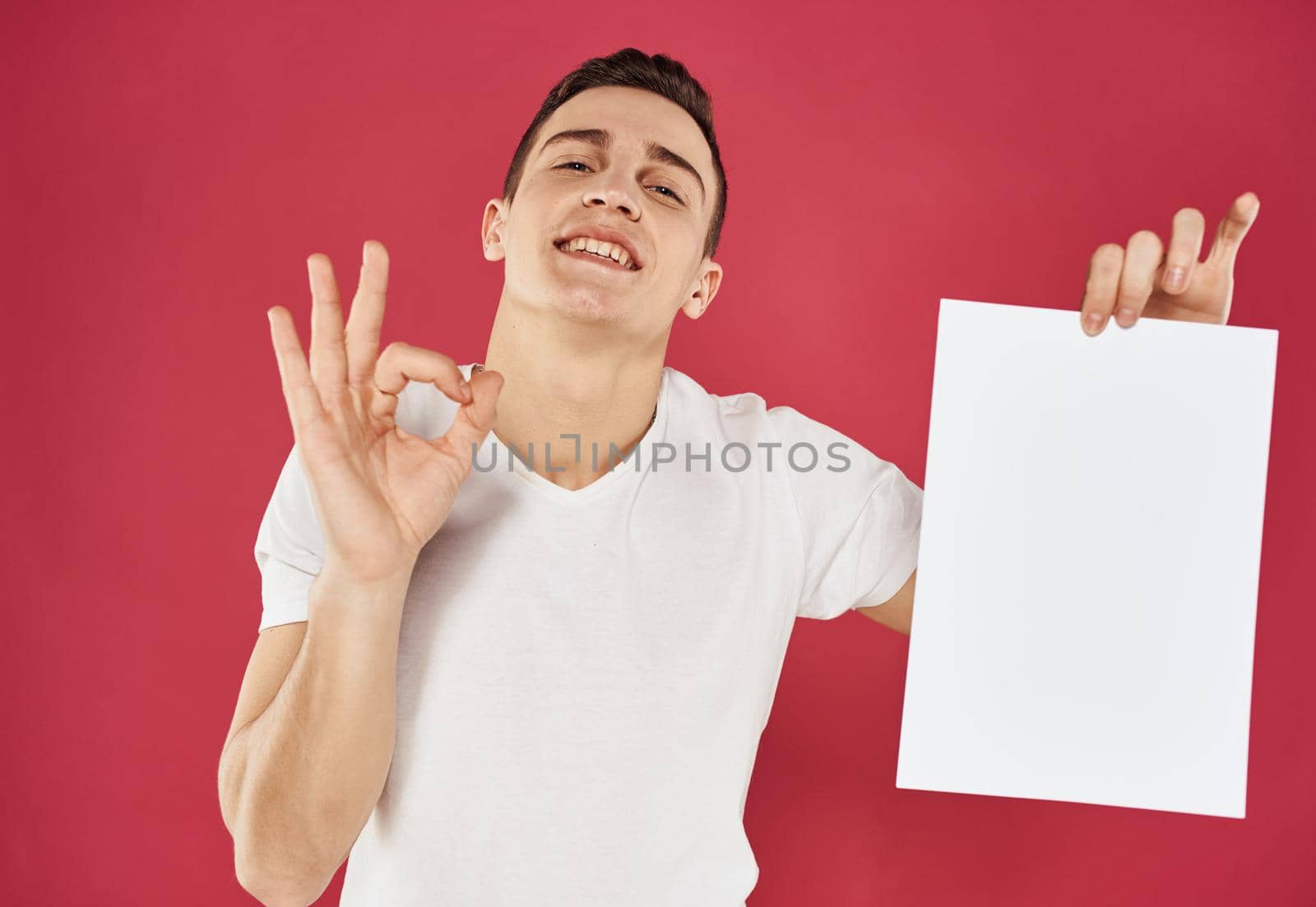 Man with white sheet of paper gesturing with hands cropped view of mockup. High quality photo