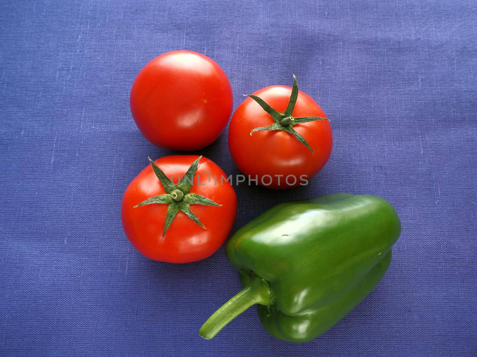 Food. Ripe vegetables close-up. Red tomatoes, cucumber, bell pepper