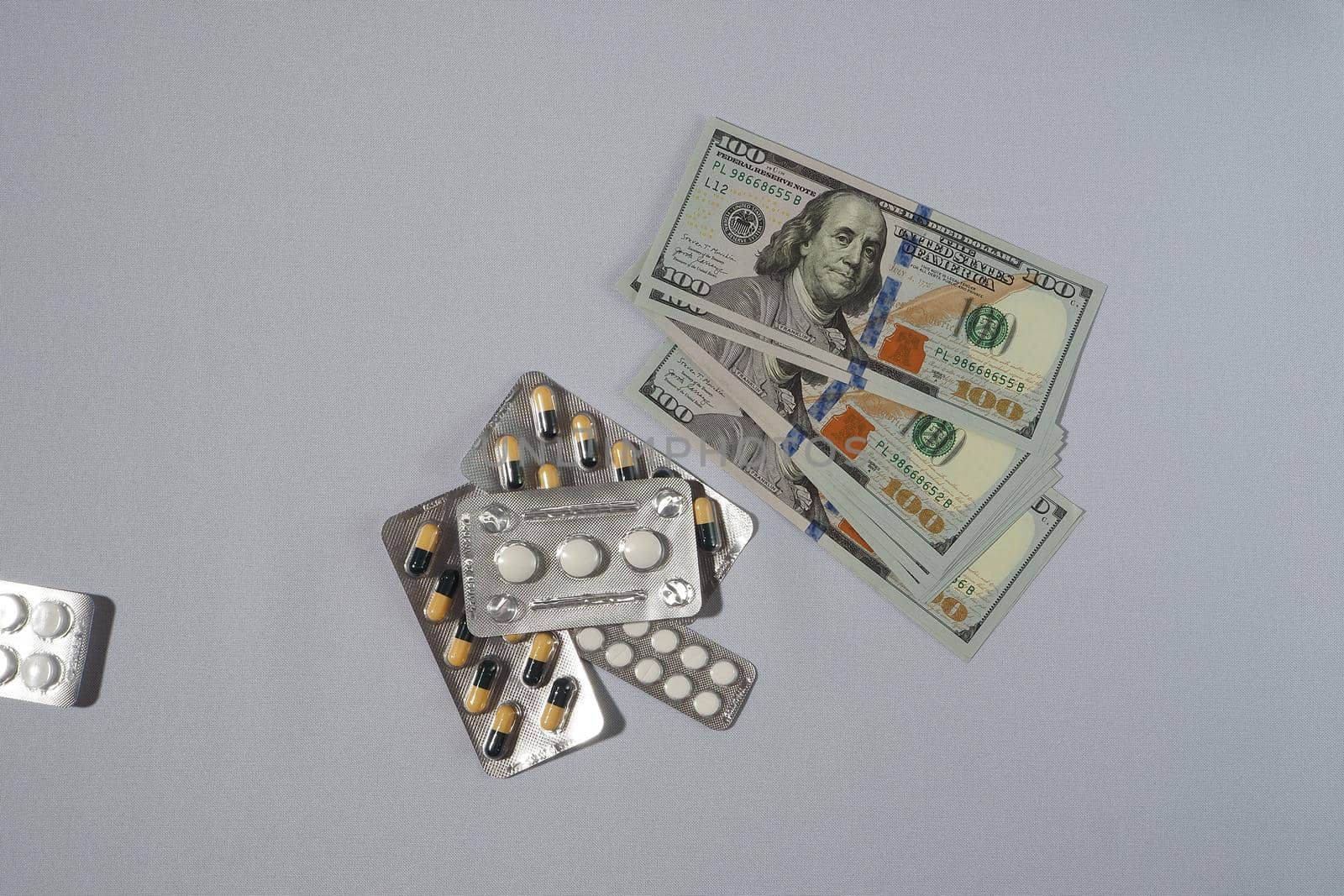 Banknotes, the US dollar, and medicines. The concept of the cost of medicines. High quality photo