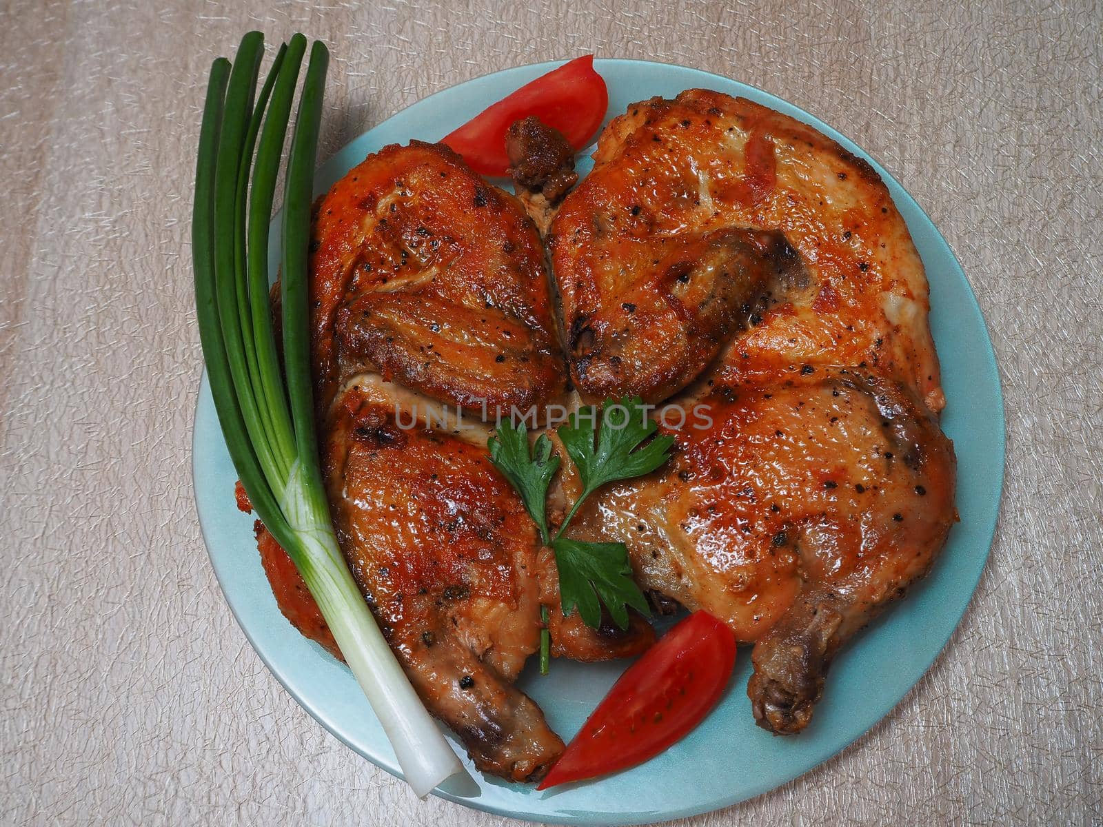 Food. Fried chicken on a plate with vegetables and green onions. Close-up, top view, high-quality image.