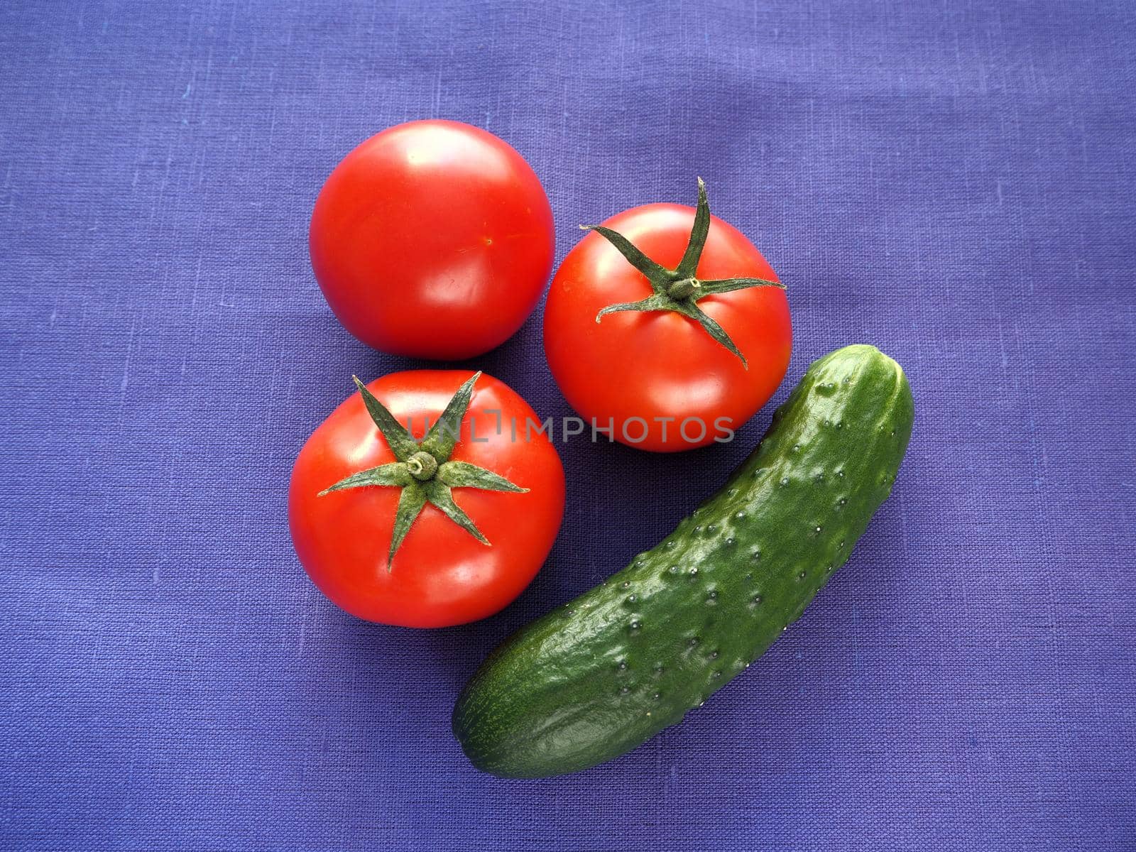 Food. Ripe vegetables close-up. Red tomatoes, cucumber, bell pepper