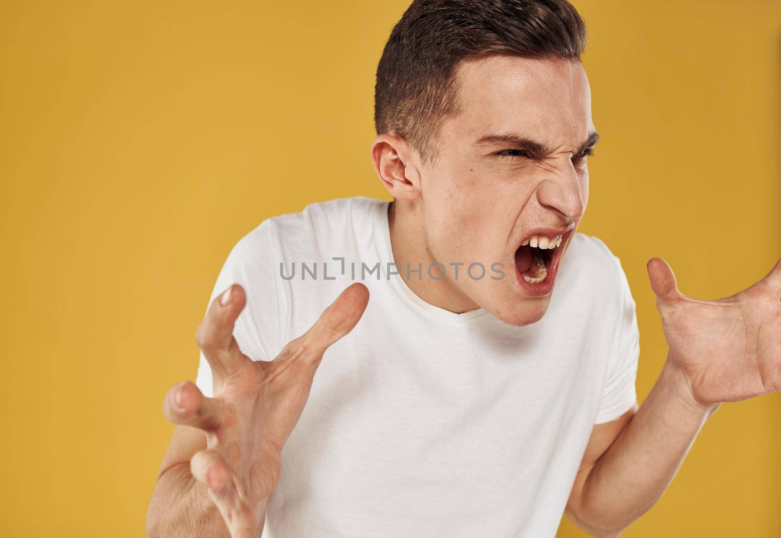 Emotional man gestures with his hands emotion model irritability stress. High quality photo