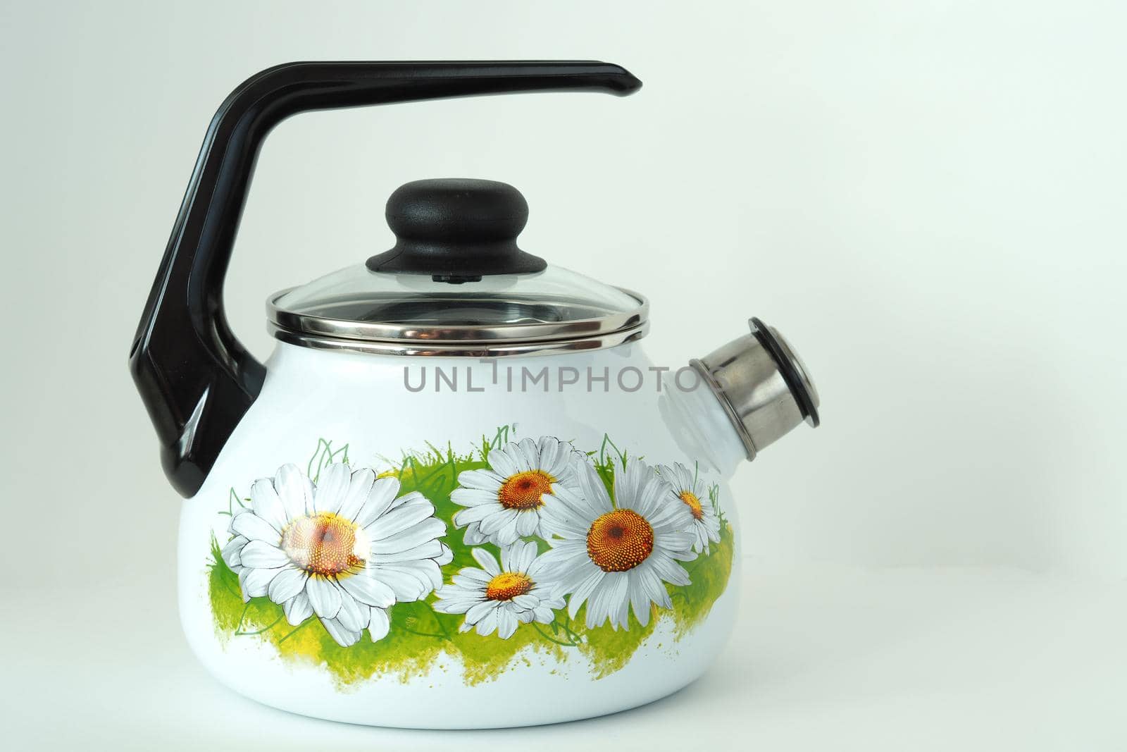 The kettle is enamelled white with a whistle and pattern. by Olga26