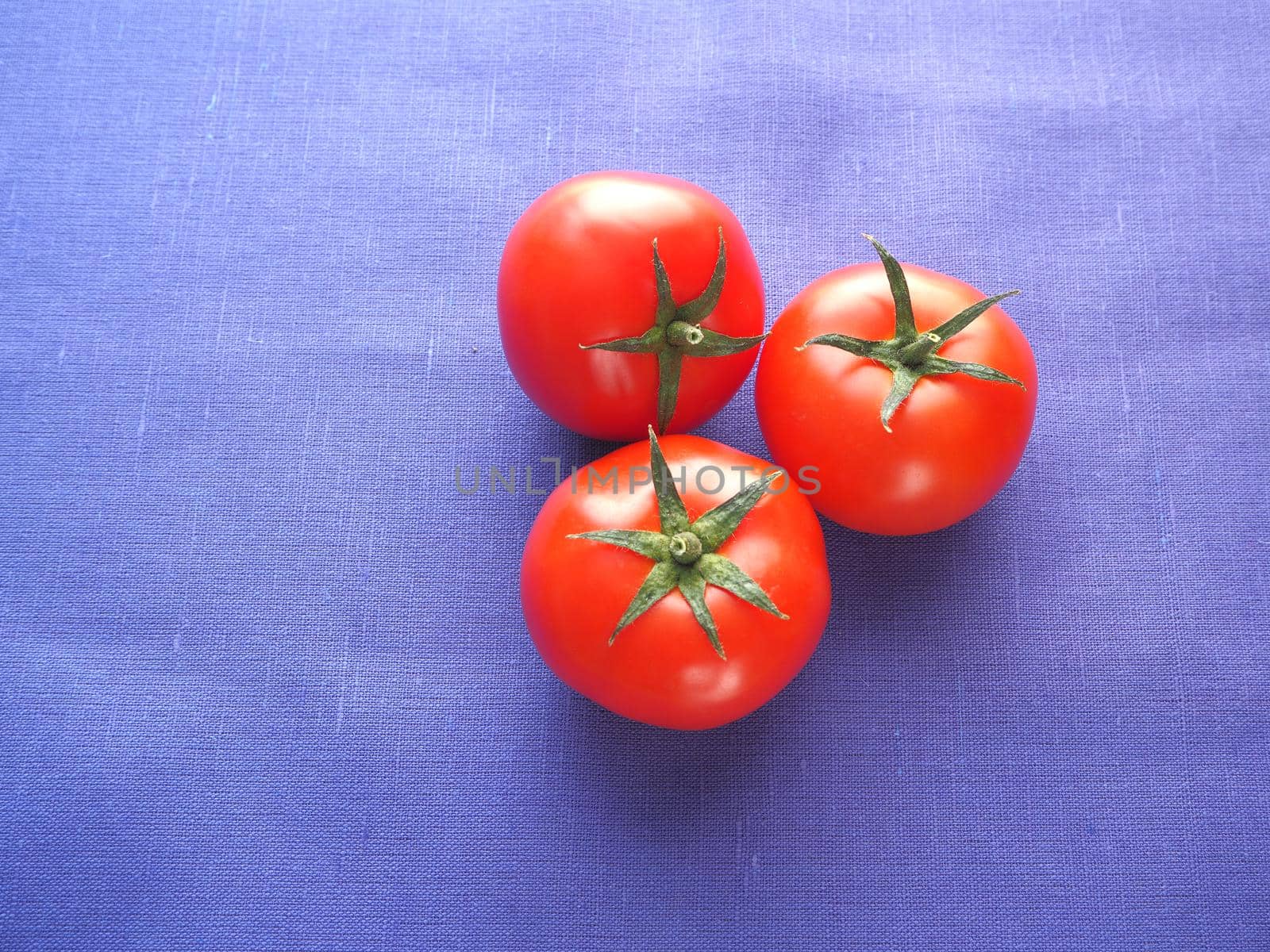 Tomatoes are fresh, red. Three close-up tomatoes. by Olga26