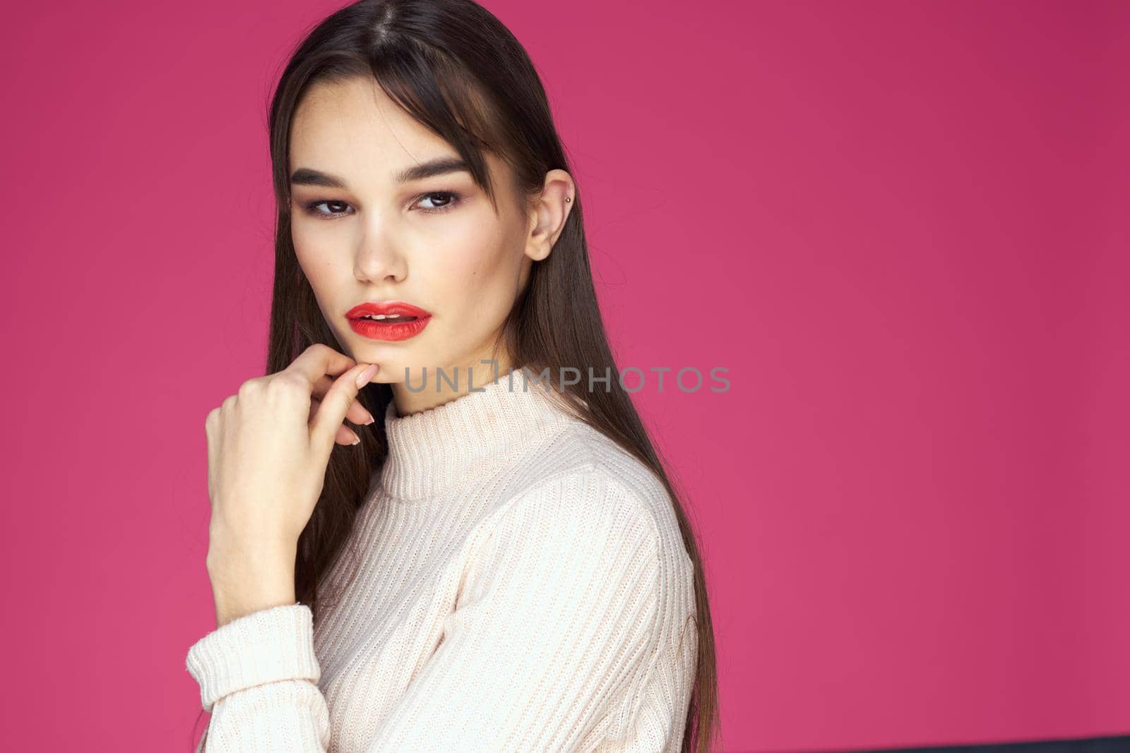 Cute brunette red lips glamor cosmetics pink background. High quality photo