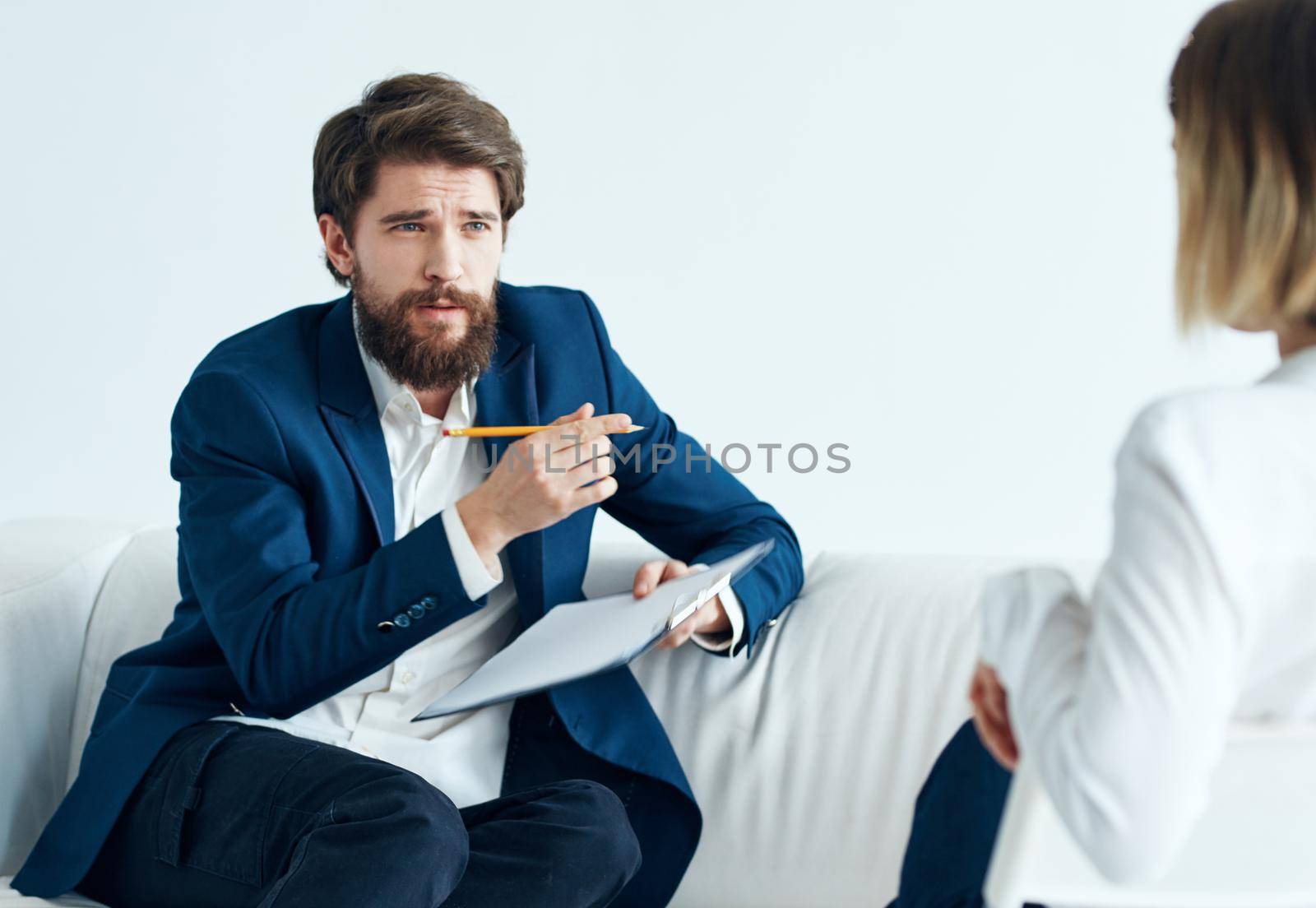 A man is a psychologist with documents and a woman at a doctor's appointment. High quality photo