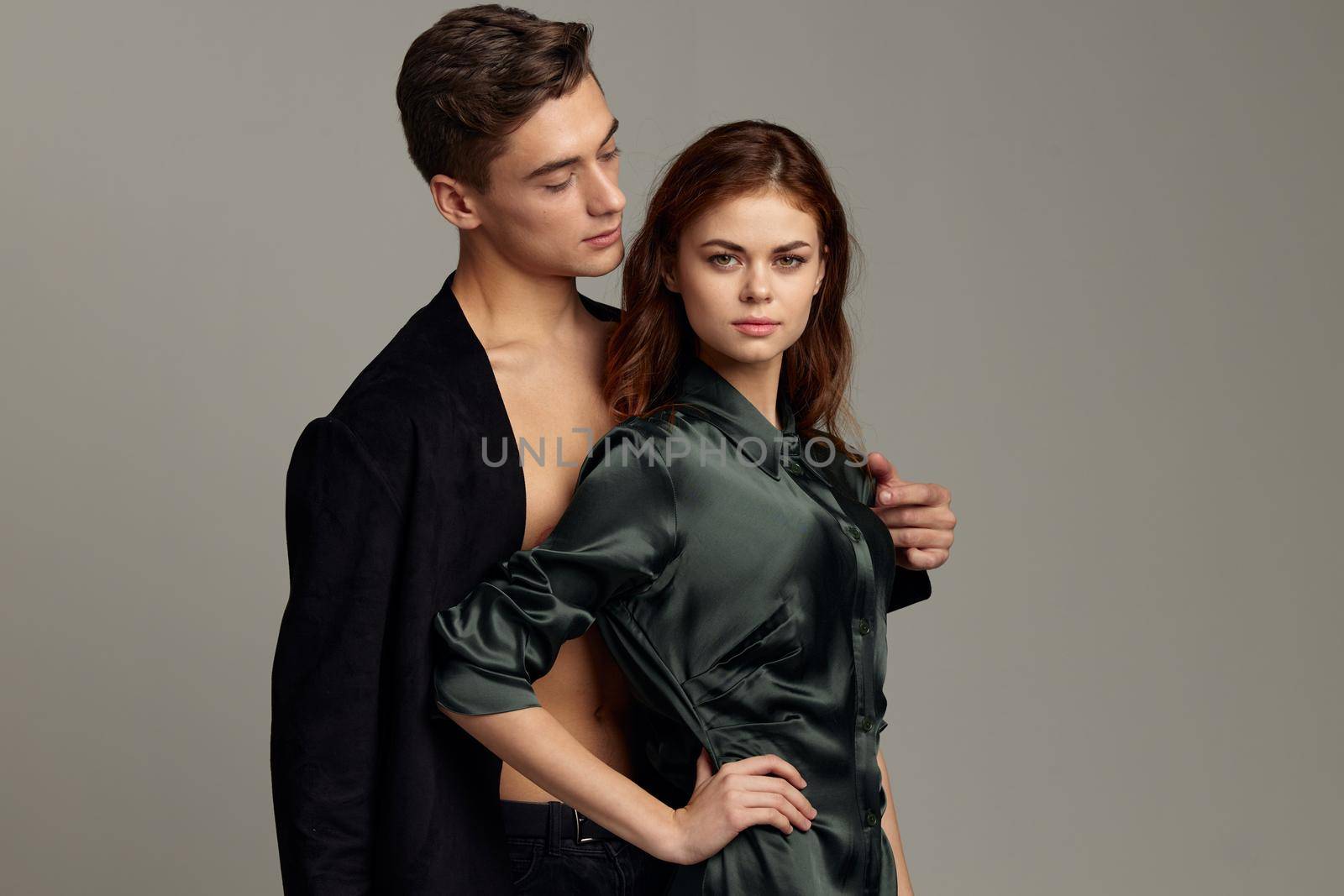 A man and a woman are standing next to a luxury stylish image. High quality photo