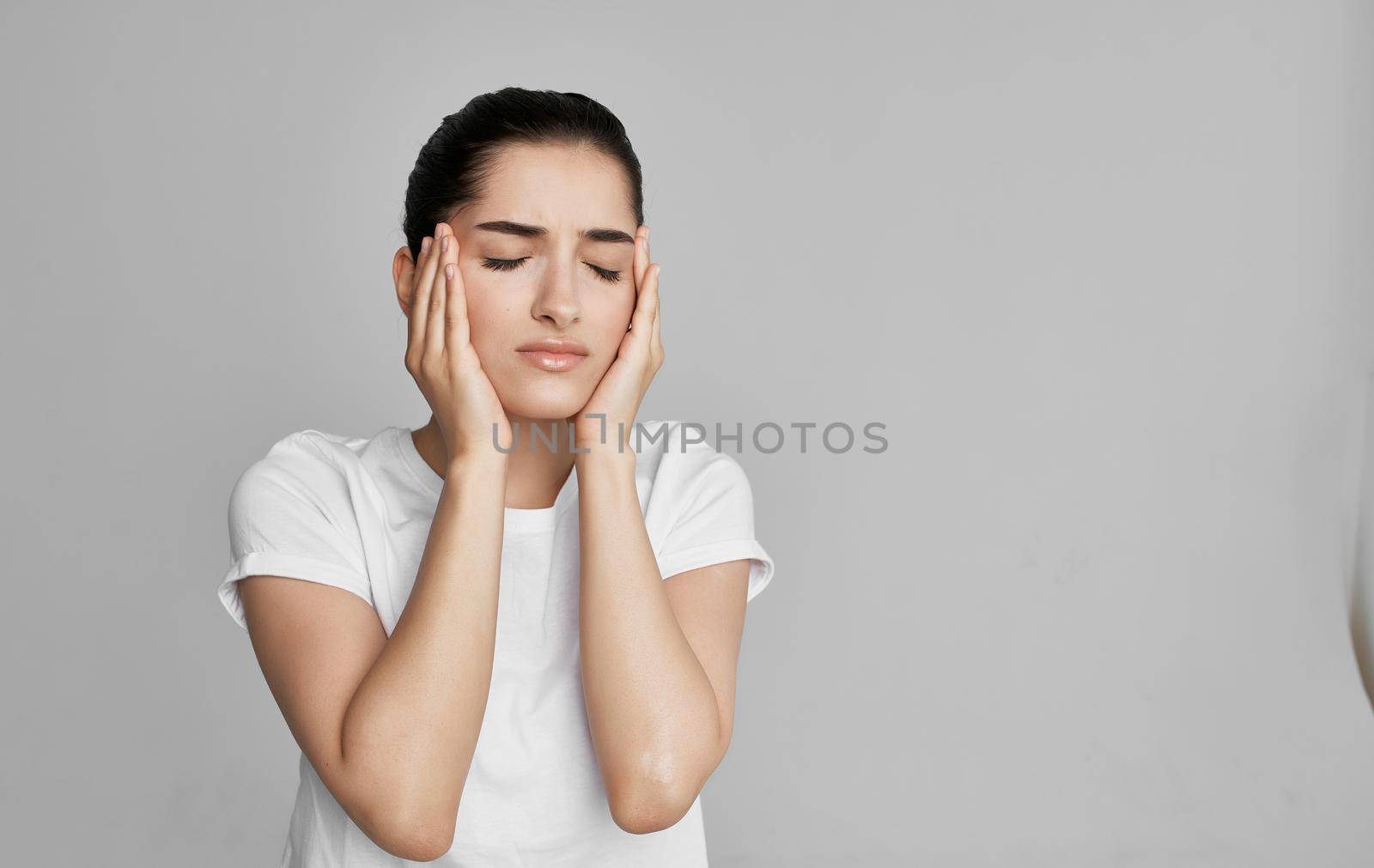 woman in white t-shirt cropped view health problem headache. High quality photo