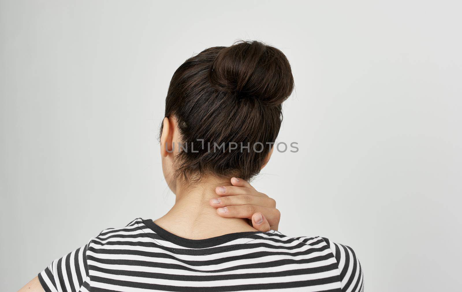 brunette in a striped t-shirt health problems headache migraine. High quality photo