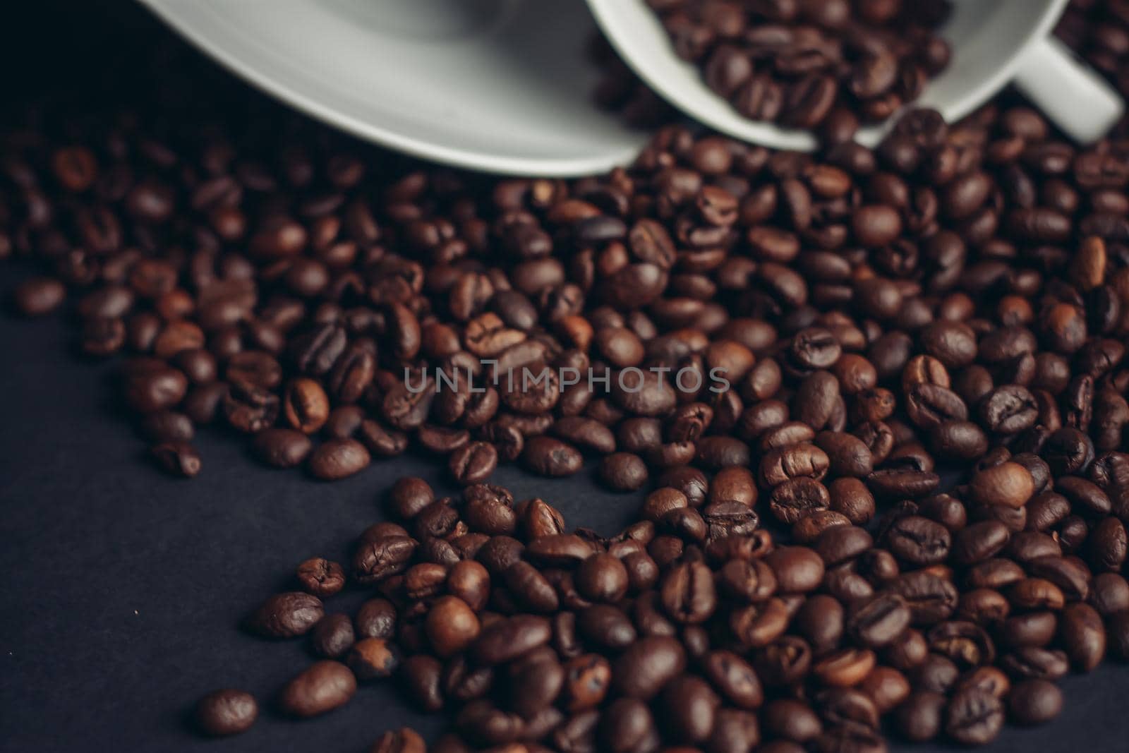 cup of coffee with brown beans on a gray background close-ups macro photography. High quality photo