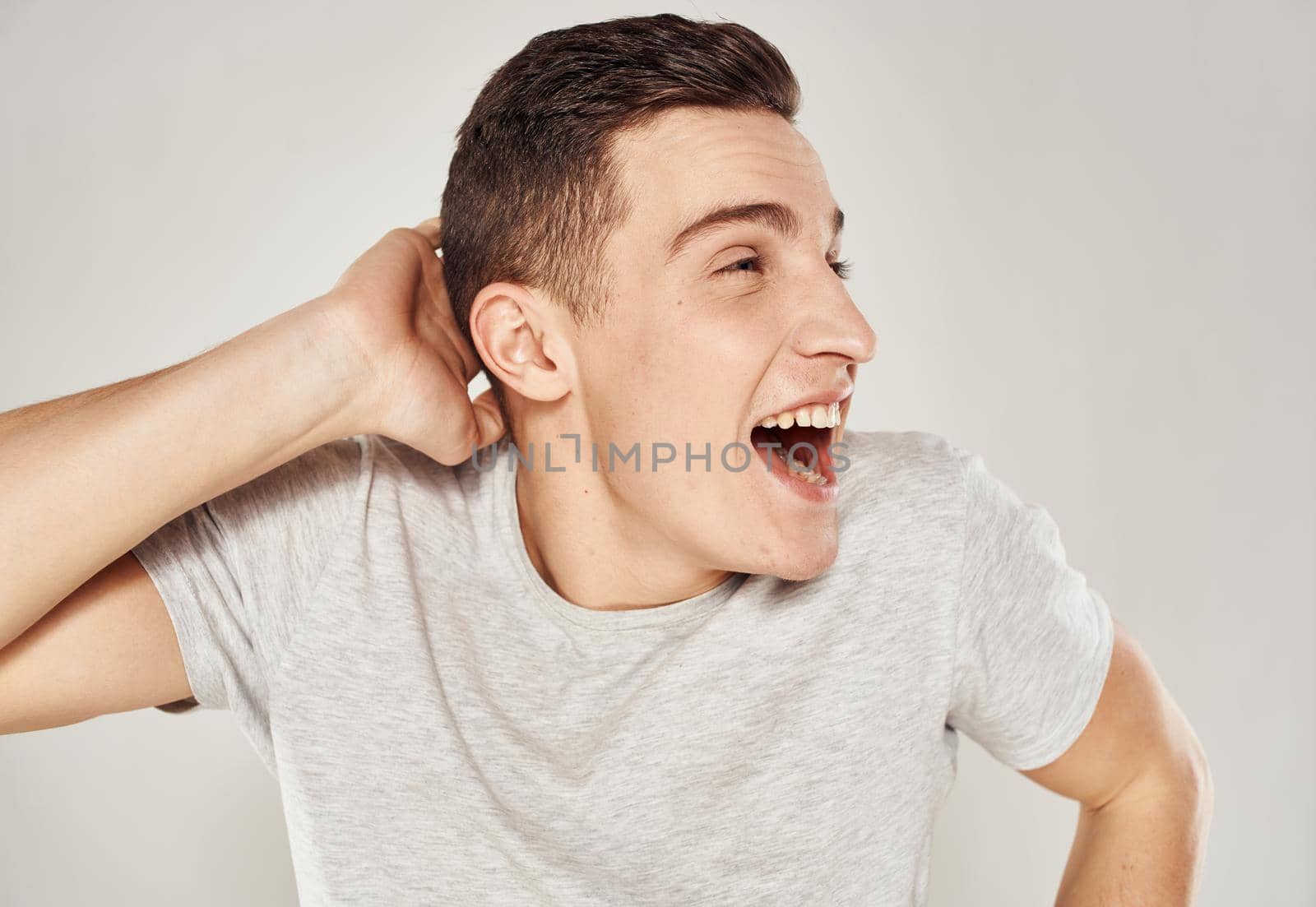 Cheerful man t-shirt emotions hand gestures close-up. High quality photo