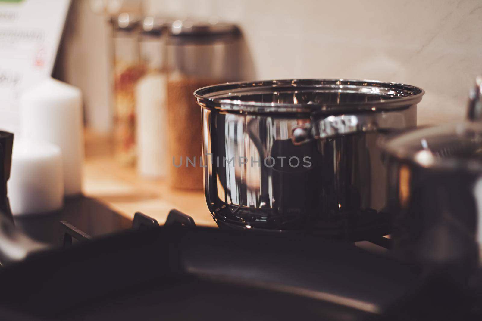 Aluminium pot on a kitchen stove, cookware and cooking concept