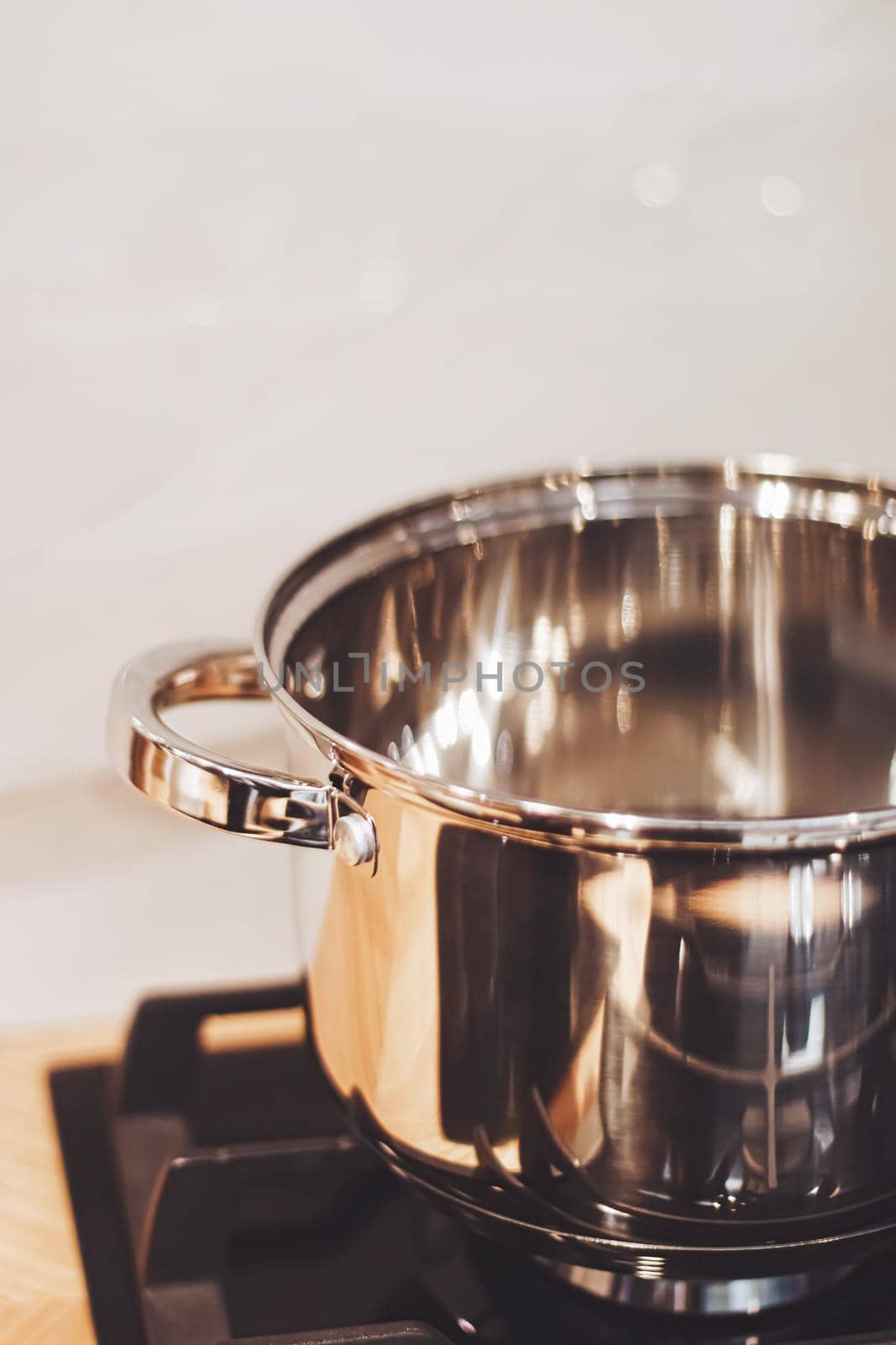 Aluminium pot on a kitchen stove, cookware and cooking concept