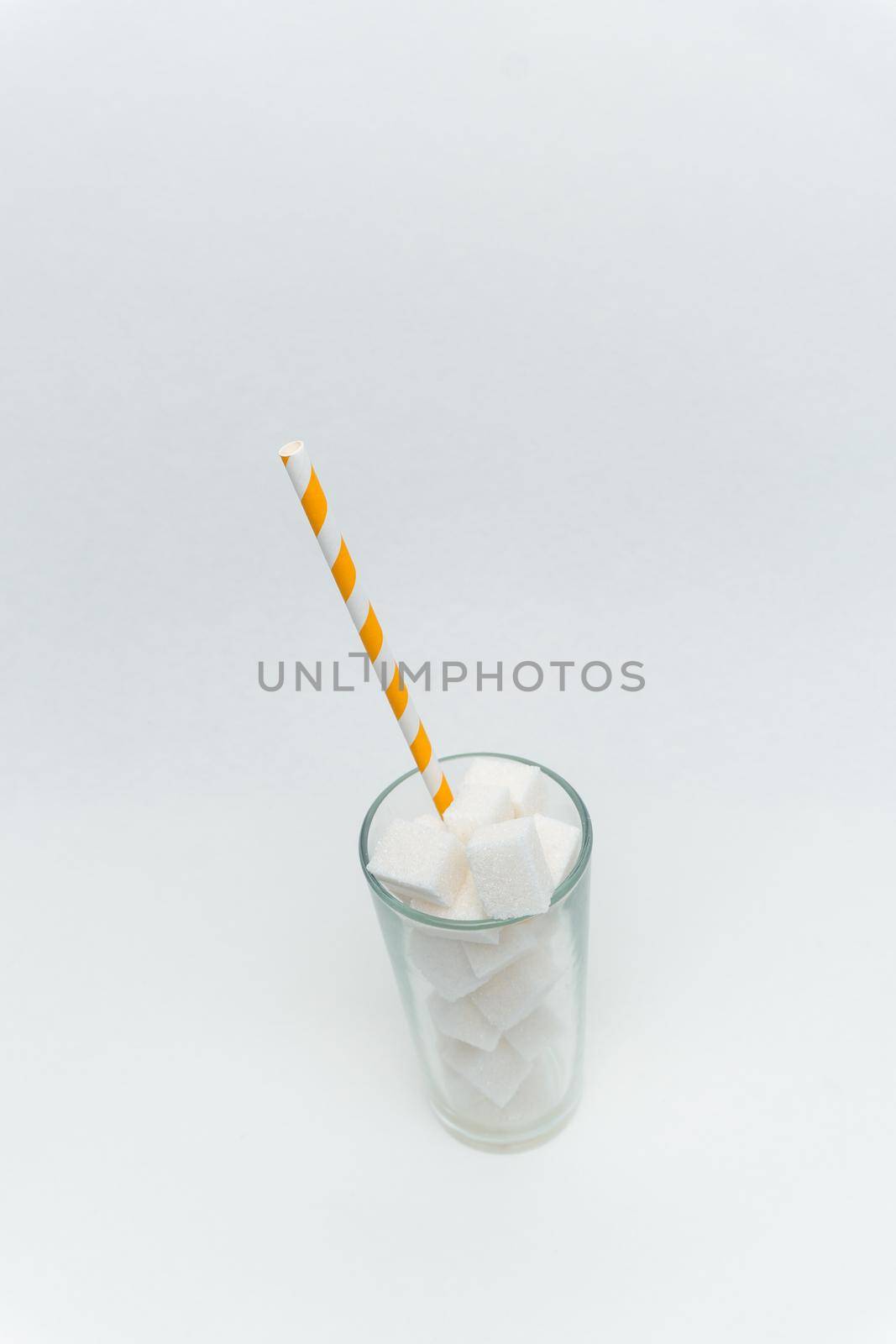 sugar cubes in a glass with a tube high-calorie sweet by SHOTPRIME