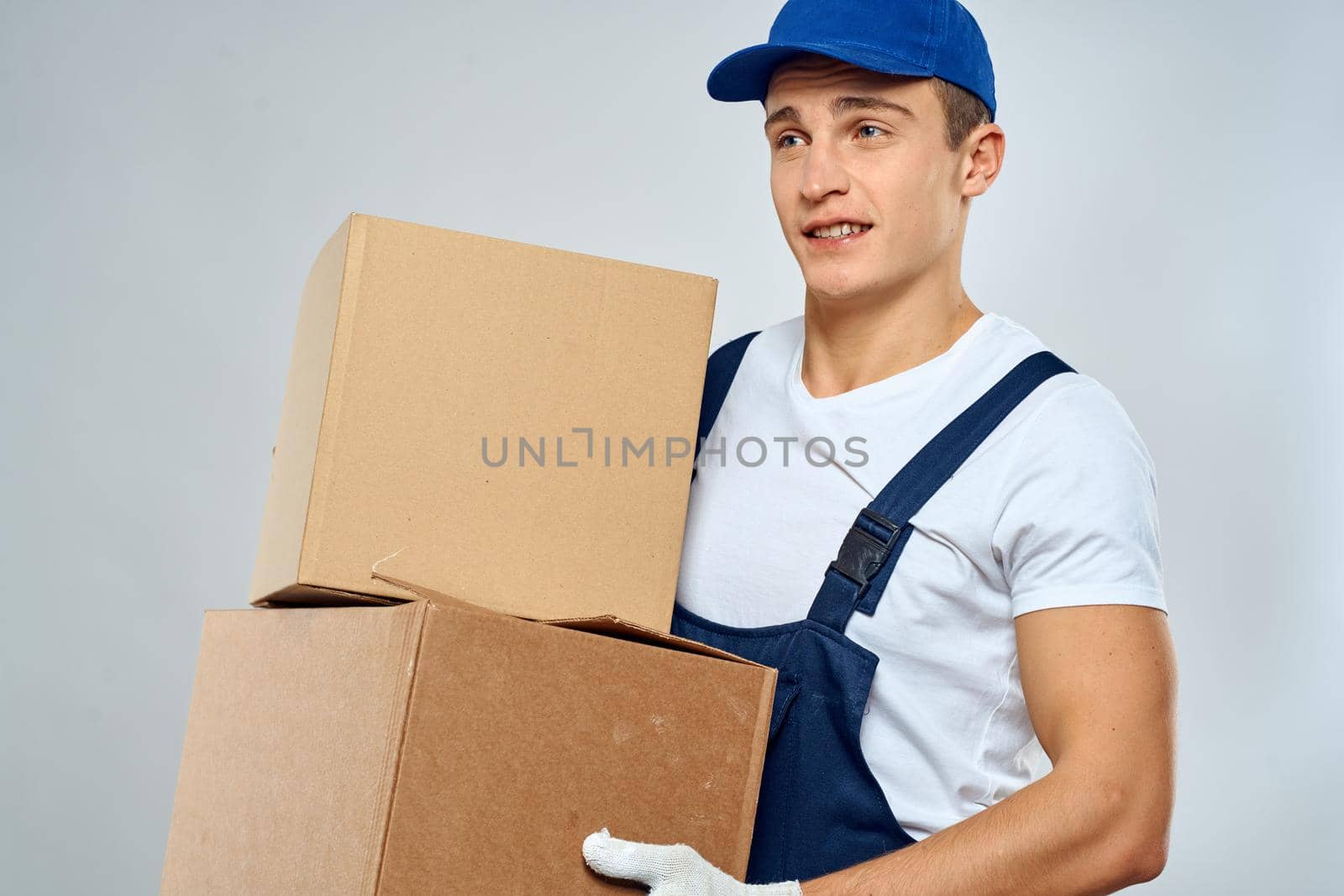 Man in working uniform blue box cap loading service professional. High quality photo