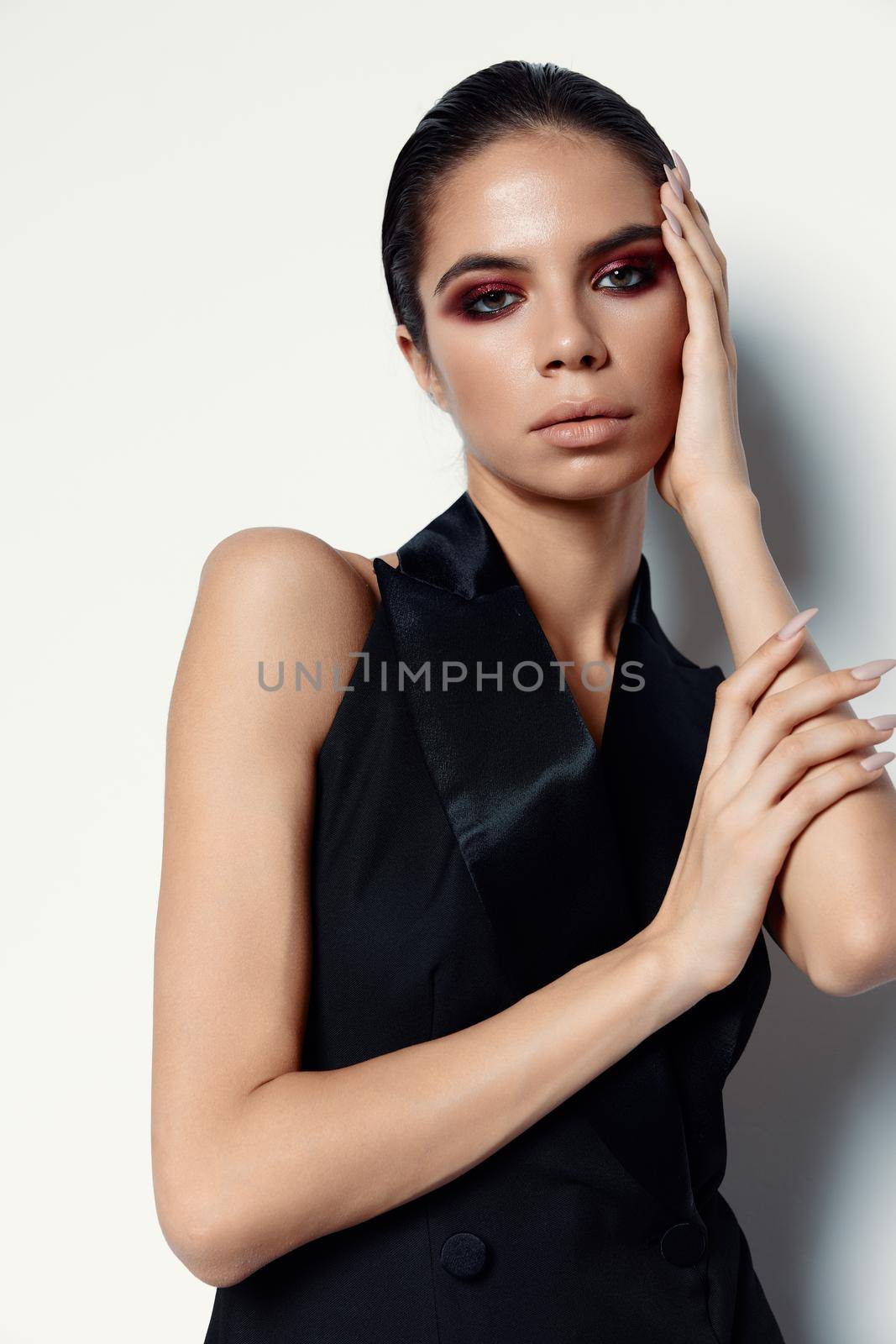 lady with bright makeup in an evening dress on a light background cropped view close-up. High quality photo