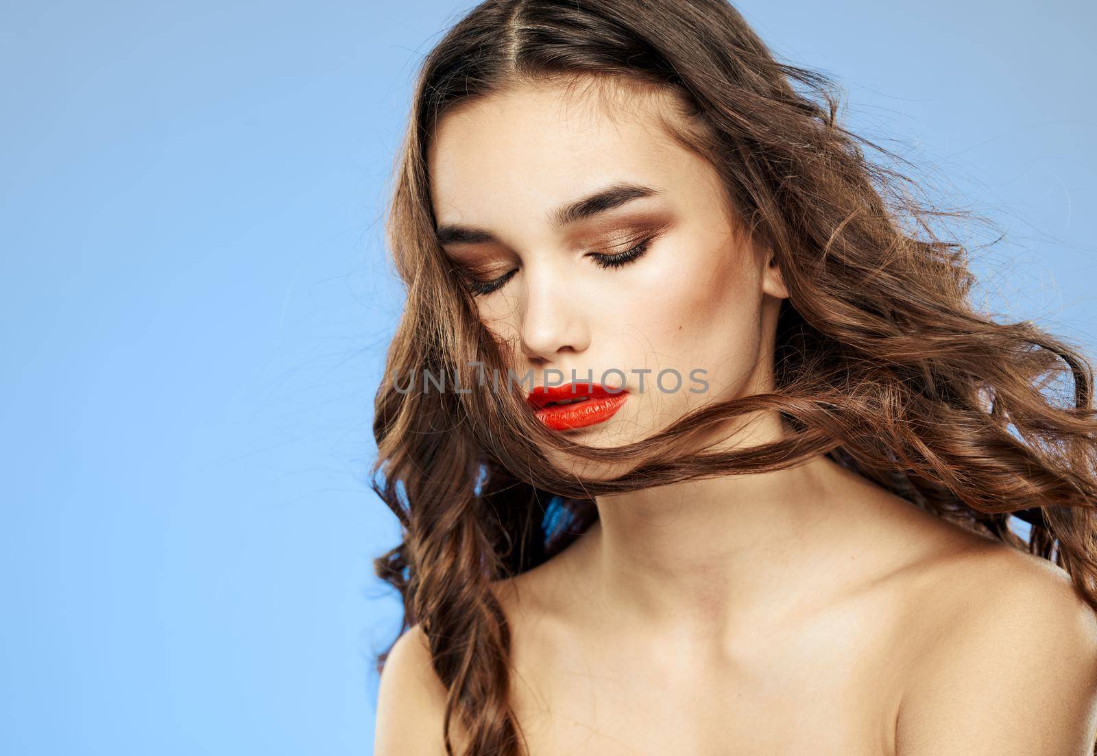 Woman on a dim background with long hair and red lips model makeup by SHOTPRIME