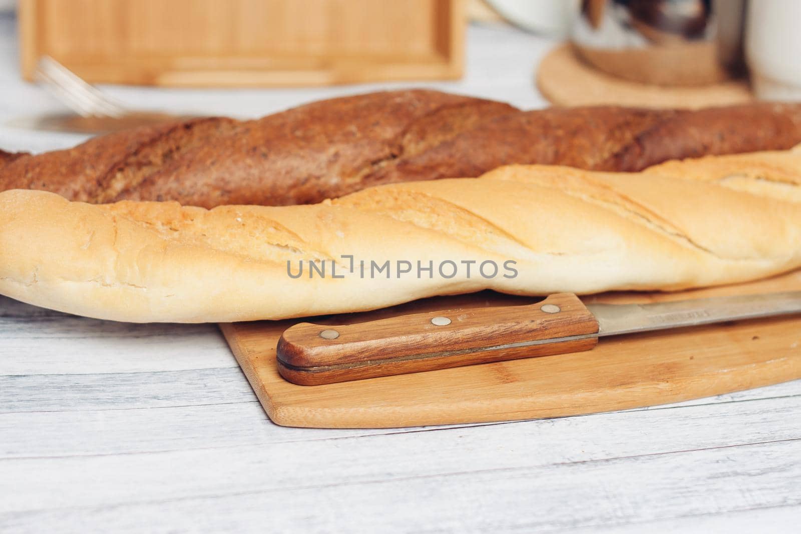 fresh loaf bread bins on the table kitchen food ration . High quality photo