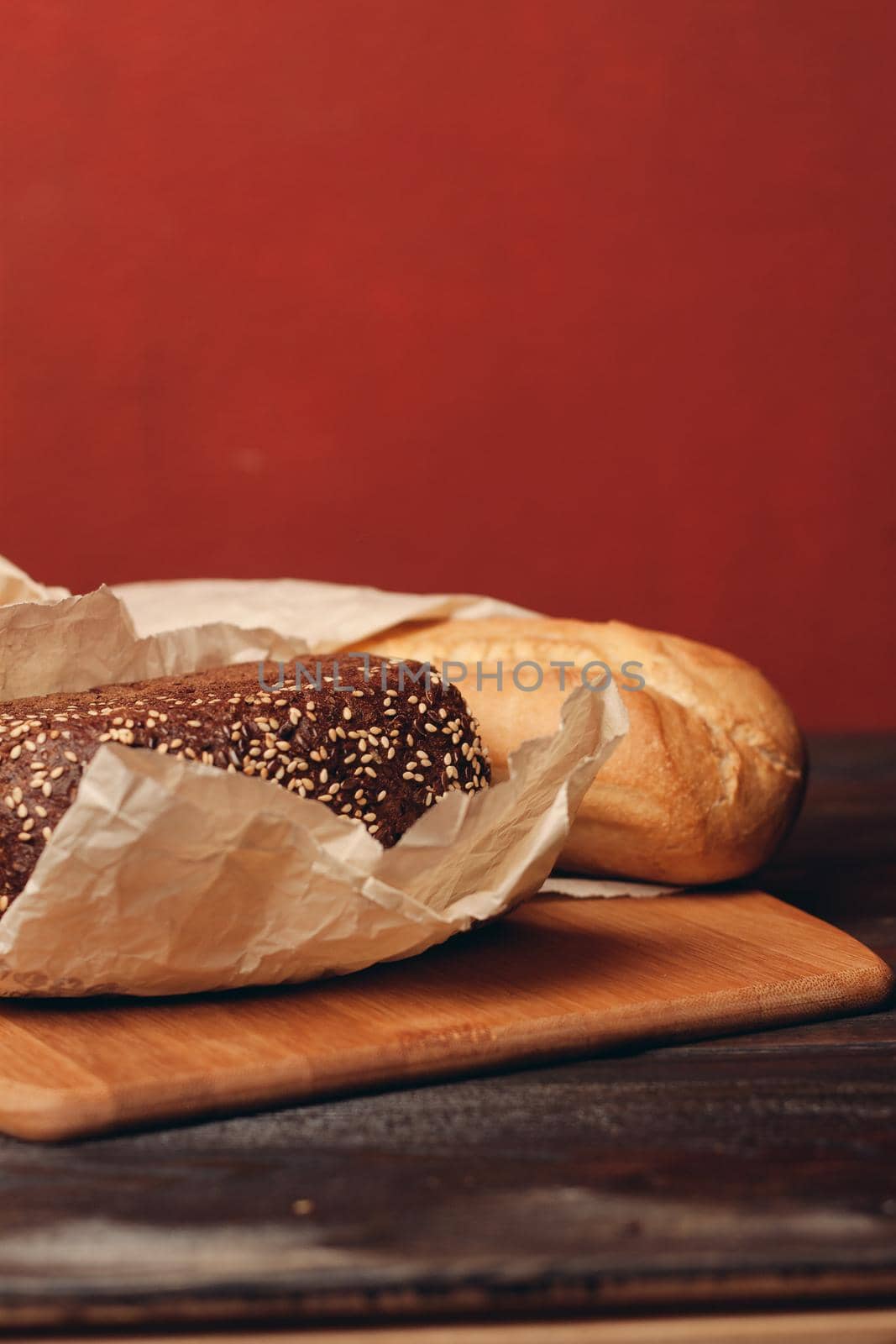 loaf of bread on a board baking flour product and red background. High quality photo