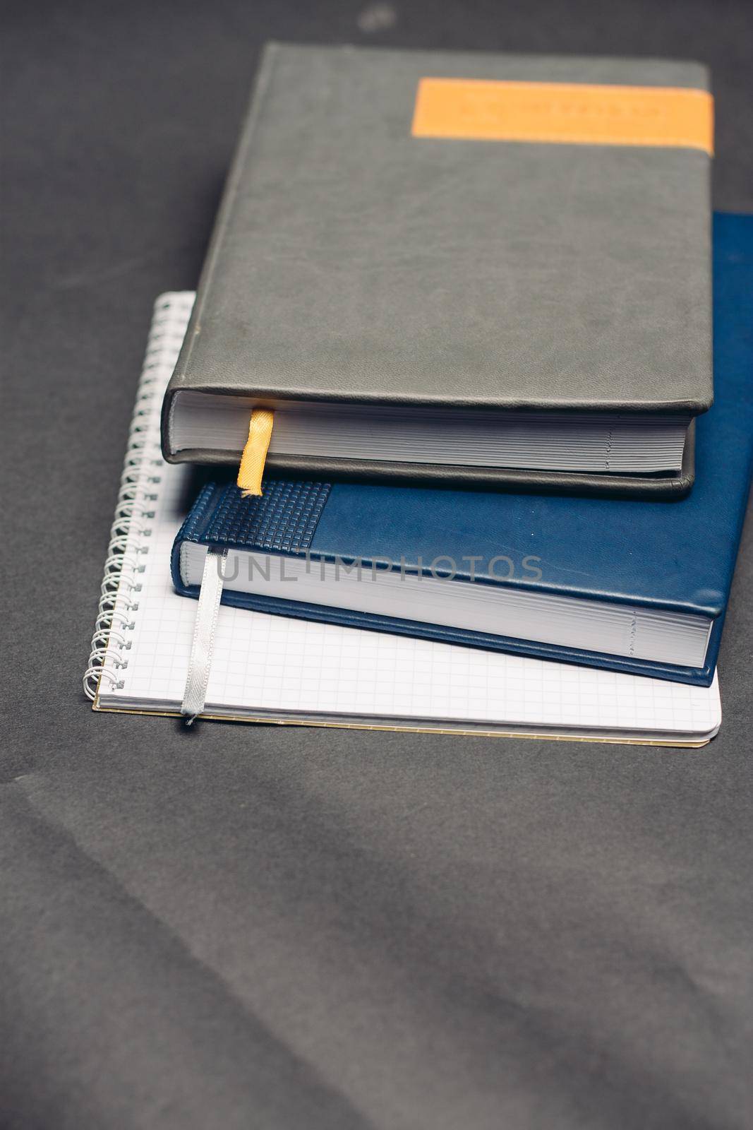 desktop notepad and papers pens gray background close-up. High quality photo