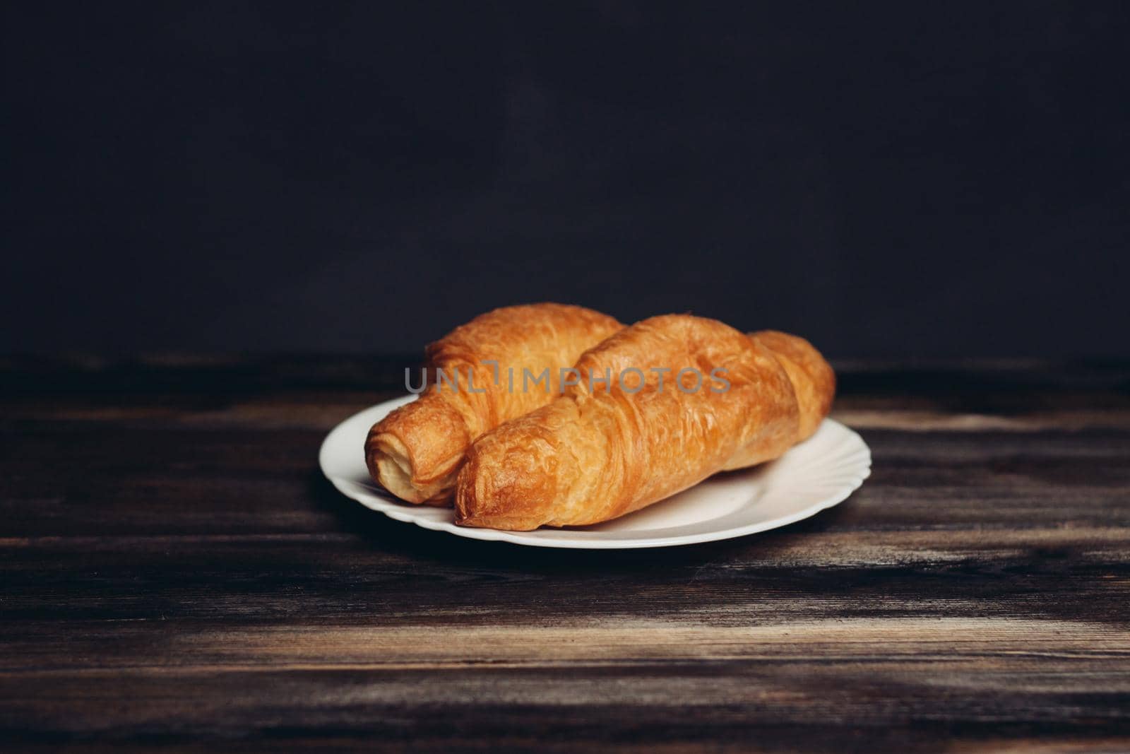 croissants plates wooden table drink mug breakfast dessert. High quality photo