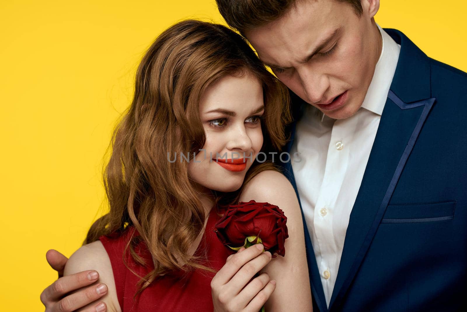 Man and woman date rose luxury yellow background. High quality photo